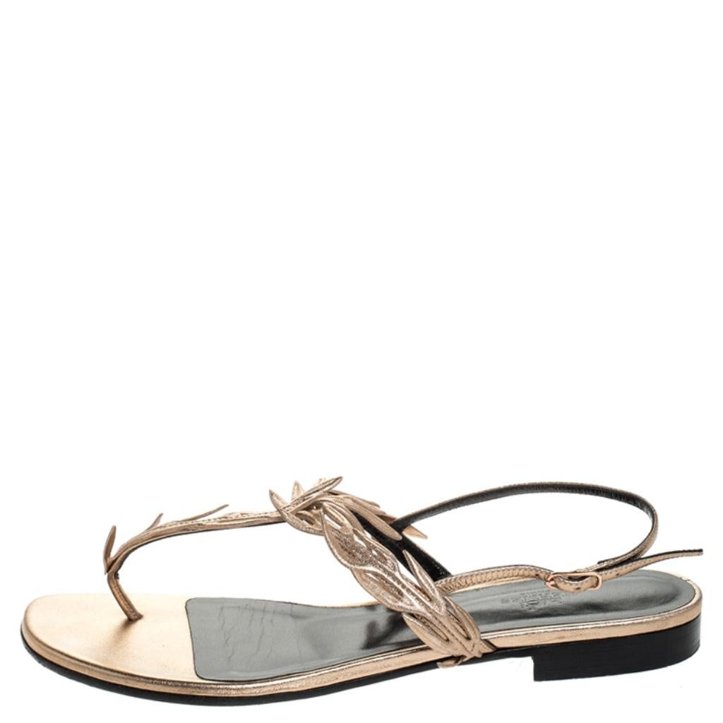 Keep it casual and chic with these flats from Hermes. Step out in style with these leather thong sandals that come in a lovely rose gold hue. They feature buckled ankle straps, delicate front straps that add a touch of femininity, leather lining,