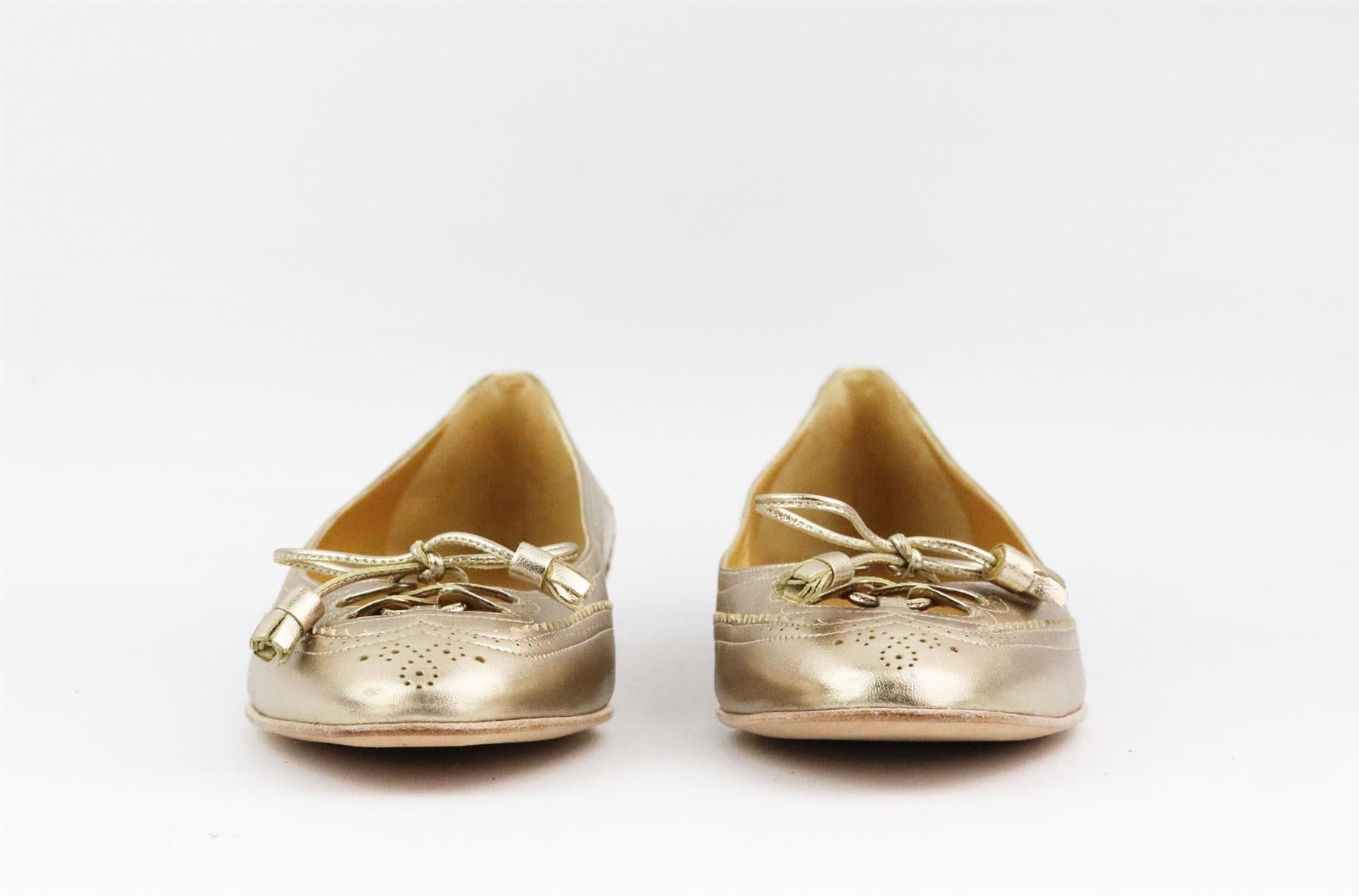 These ballerina flats by Hermès are traced with loafer-inspired leather and tassels along the almond toe, expertly crafted in Italy from leather and detailed with bow detail on the top. Heel measures approximately 7.6 mm/ 0.3 inches. Metallic-gold