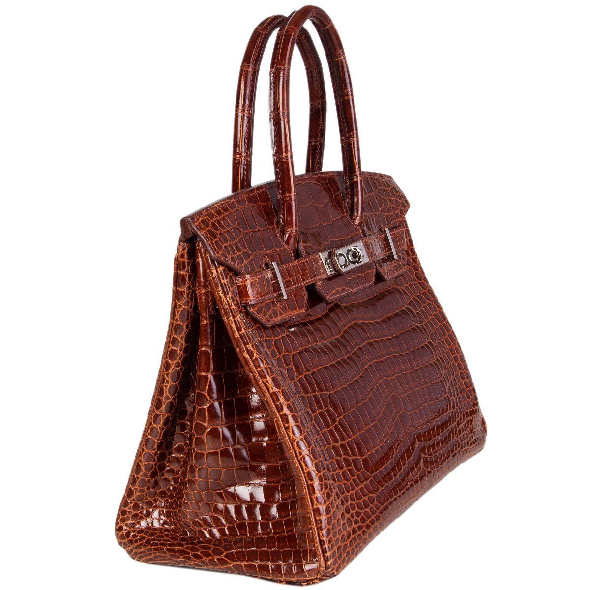 Hermes 'Birkin 30' bag in Miel (honey brown) shiny porosus crocodile leather. Lined in Chevre (goat skin) with an open pocket against the front and a zipper pocket against the back. Has been carried and is excellent condition except for one water