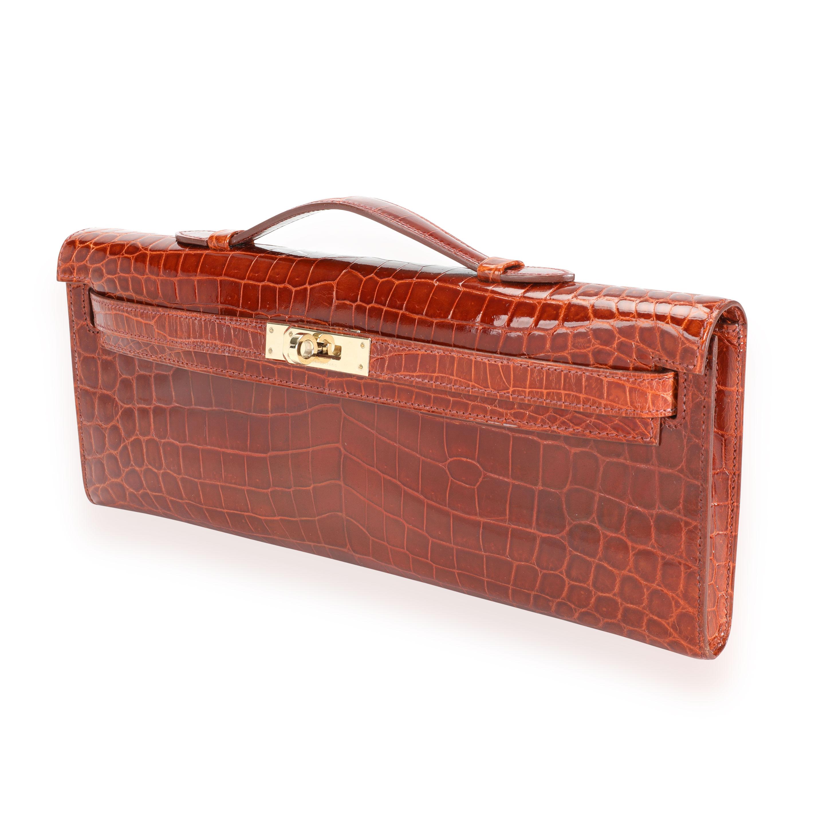 Hermès Miel Shiny Niloticus Crocodile Kelly Cut GHW
SKU: 111768
MSRP:  
Condition: Pre-owned (3000)
Condition Description: 
Handbag Condition: Very Good
Condition Comments: Very Good Condition. Plastic on some hardware. Scratching to hardware. Light