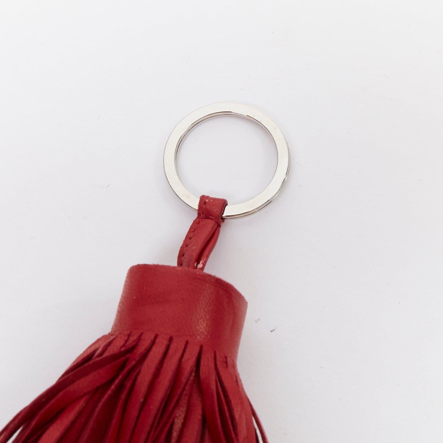 HERMES Milo Carmen red leather tassel silver ring bag charm
Reference: AAWC/A01349
Brand: Hermes
Material: Leather
Color: Red, Silver
Pattern: Solid

CONDITION:
Condition: Fair, this item was pre-owned and is in fair condition. Please refer to image