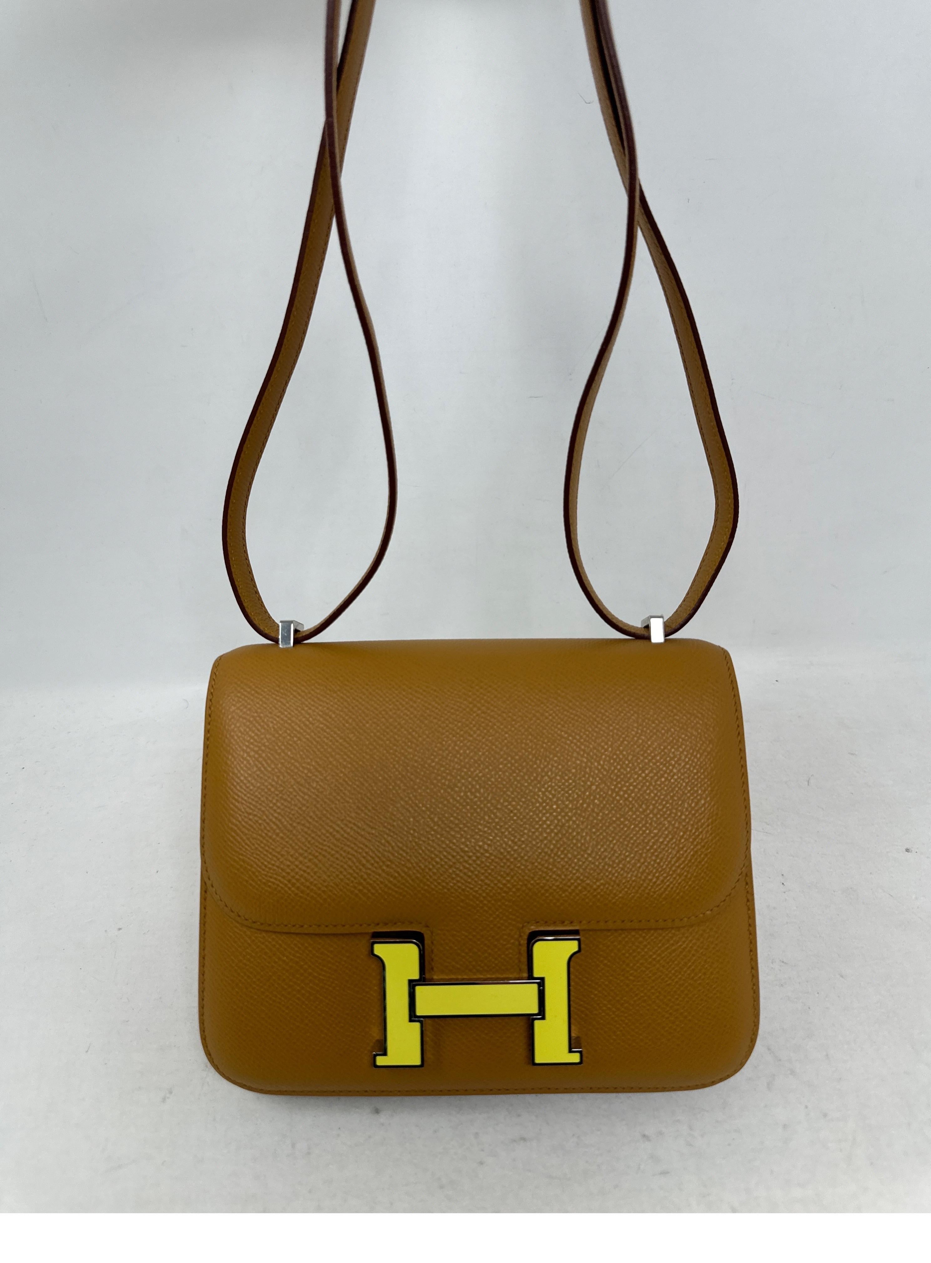 Hermes Mini Constance Gold Bag with yellow enamel hardware. Gold tan color leather with rare H closure. Constance 18 size. Excellent condition. Like new. Interior clean. Full set. Dust bag and box included. Guaranteed authentic. 