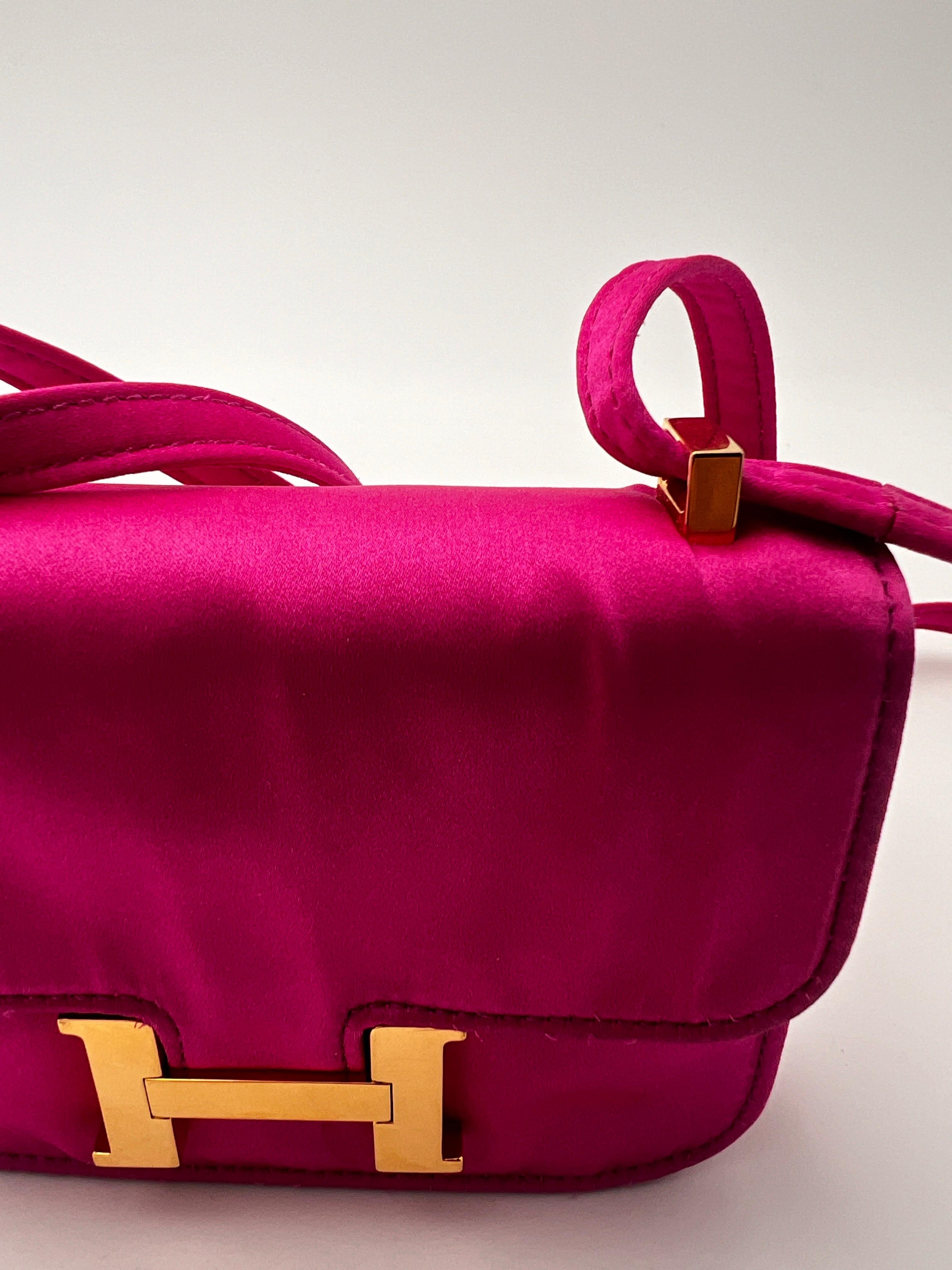 Vintage Hermès Mini Constance pink satin bag with gold hardware. Crossbody or shoulder strap. 
Purple inside. 
Stamp Hermes Made in France.