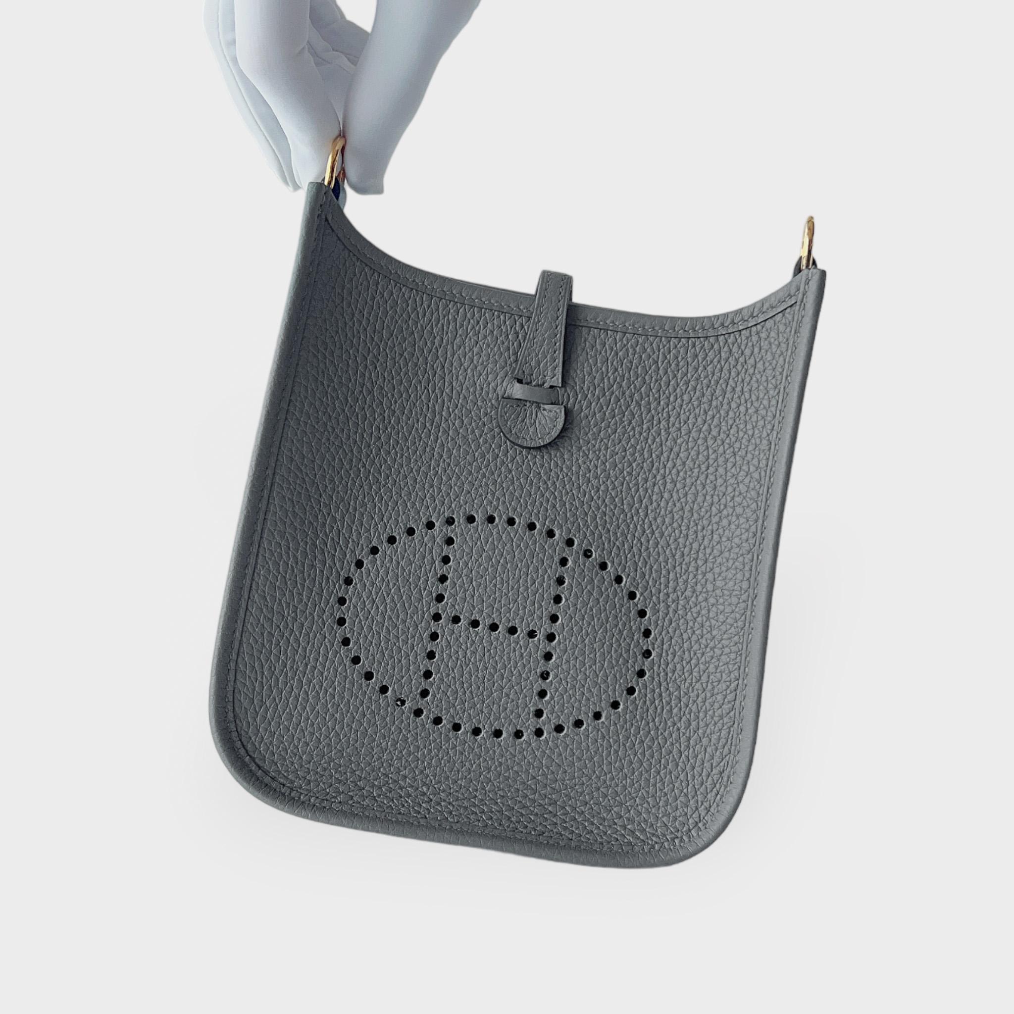 The Hermes Mini Evelyne 16 in Gris Meyer is a casual design that can be used for your everyday routine. This is the smallest size Hermes Evelyne bag and is made from handcrafted Gris Meyer Clemence leather, making it harder to scratch or become