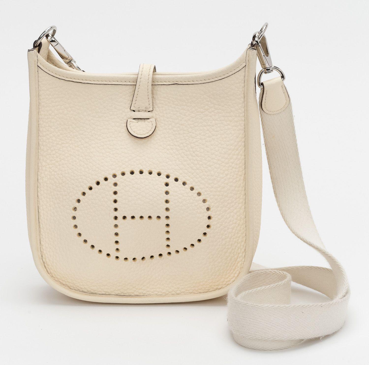 Hermès mini Evelyne Crossbody Bag parchemin in clemence leather with palladium hardware. The bag is in excellent condition and comes with a shoulder strap. (minor wear on the strap). Also the original box will be with the bag.