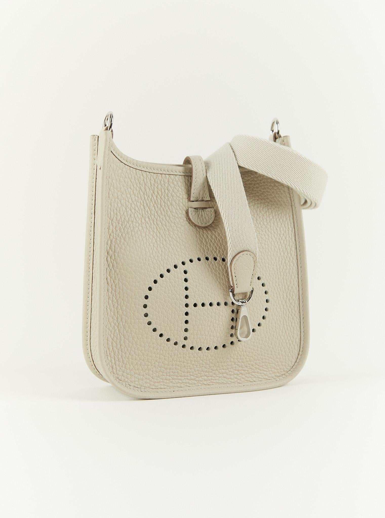 Hermès Mini Evelyne TPM in Beton

Clemence Leather with PalladiumHardware

Canvas Shoulder/Crossbody strap

B Stamp

Accompanied by:  Hermes box, Hermes dustbag, shoulder strap, shoulder strap dustbag and ribbon

Measurements: W 6.75