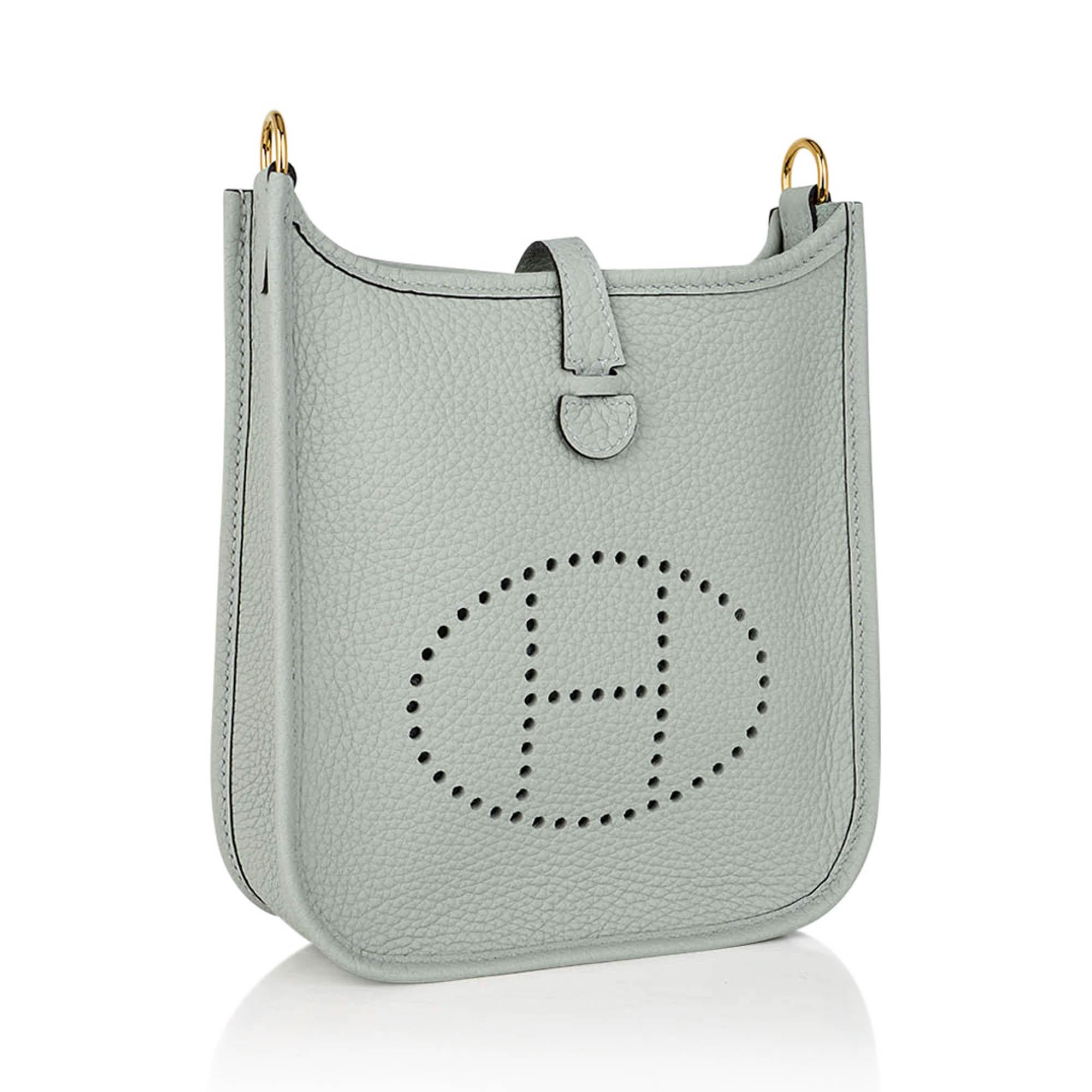 Mightychic offers an Hermes mini Evelyne TPM bag featured in Gris Neve.
Newly introduced color, it is a pale gray with a pale green cast.
A gorgeous new neutral.
In beautiful Clemence leather.
Signature perforated H on front of bag.
Lush with Gold