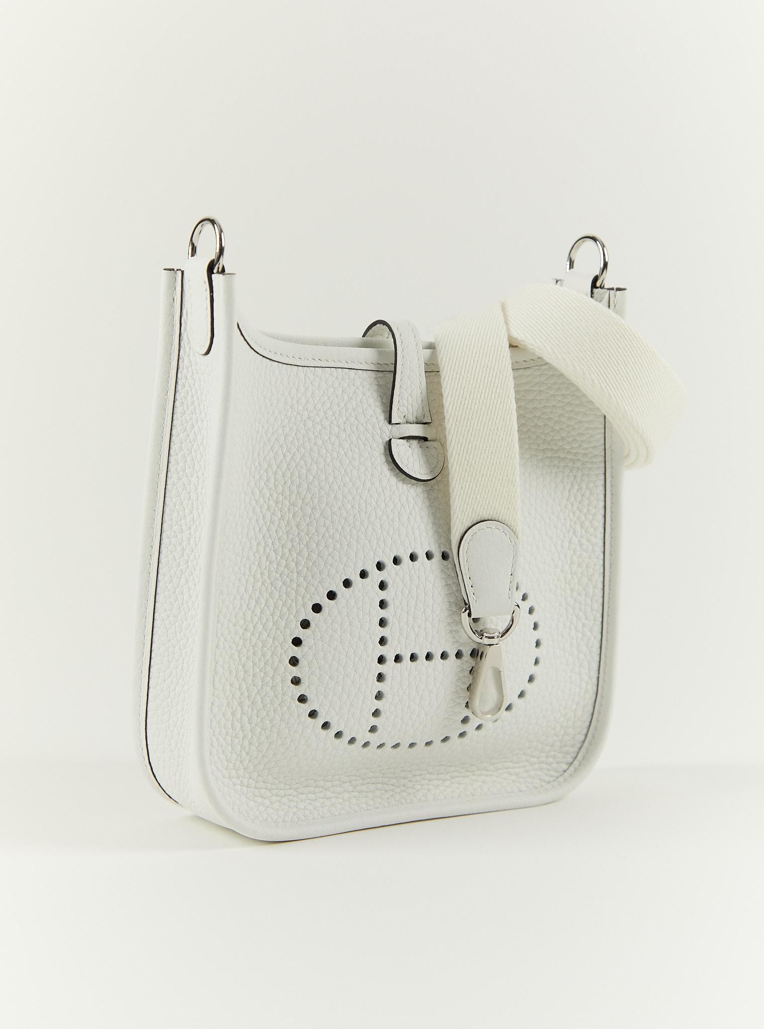 Hermès Mini Evelyne TPM in New White

Clemence Leather with Palladium Hardware 

B Stamp / 2023

Accompanied by: Original receipt, Hermes box, Hermes dustbag, shoulder strap, shoulder strap dustbag, care card and ribbon

Measurements: L 16 x H 18 x