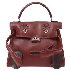 HERMÈS Mini sac cabas Kelly Doll rouge bourgogne marron en cuir à poignée supérieure