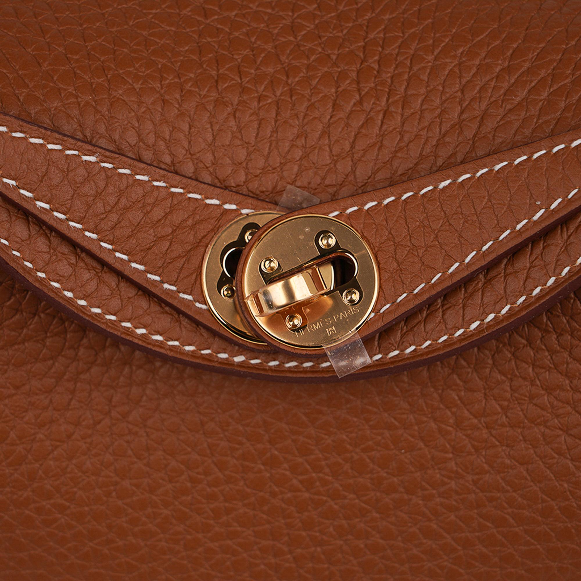 Mightychic offers an Hermes Lindy Mini 20 bag featured in classic neutral Gold
Supple soft Clemence leather.
Lush with gold hardware.
This versatile bag can be carried by hand, crossbody or on the shoulder.
Spacious interior with an interior pocket