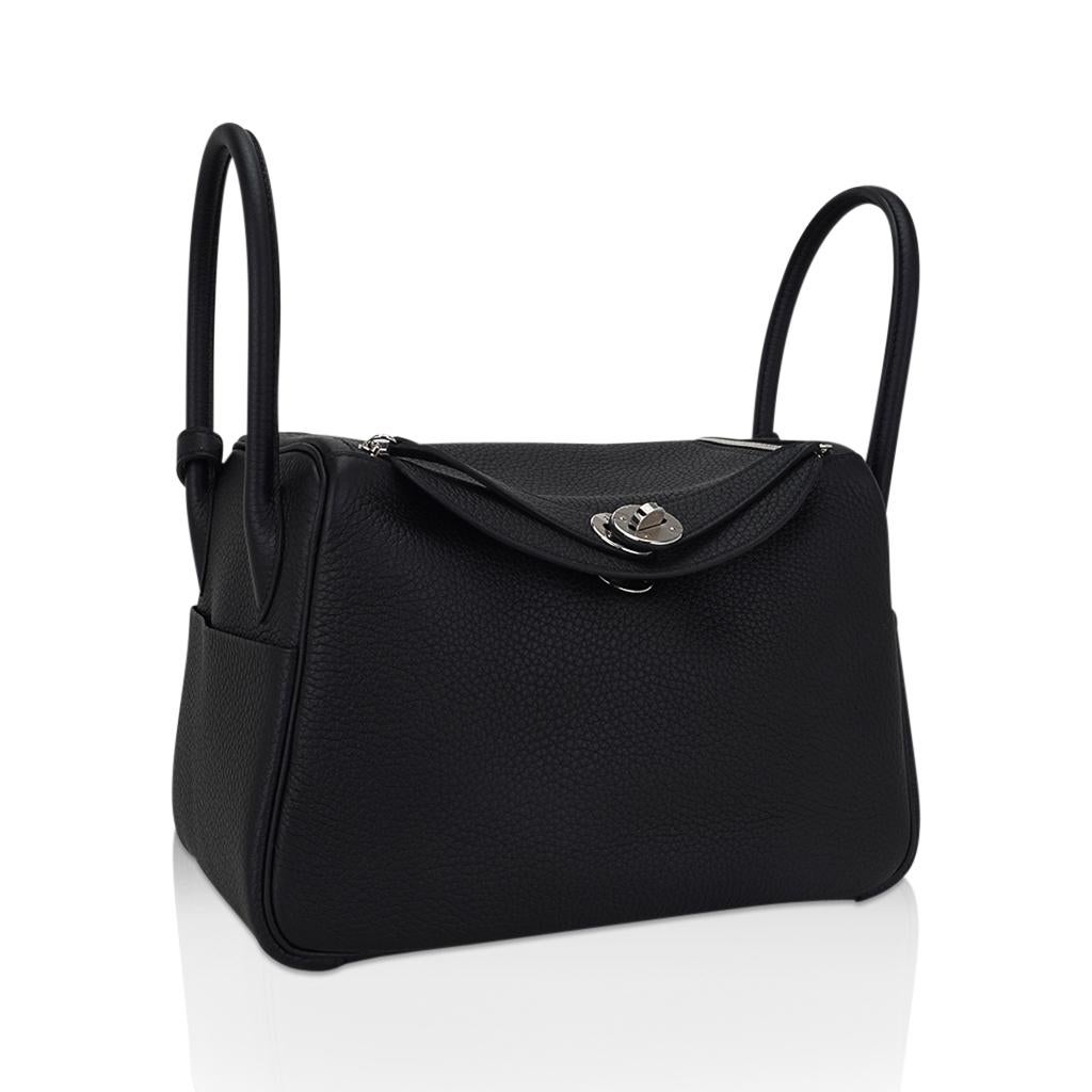 Mightychic offers an Hermes Lindy 26 bag featured in Black.
Plush Clemence leather.
Crisp with Palladium hardware.
Functional as a top handle bag or a hands free shoulder bag.
Exterior pocket on each side and surprisingly spacious interior.
Top has