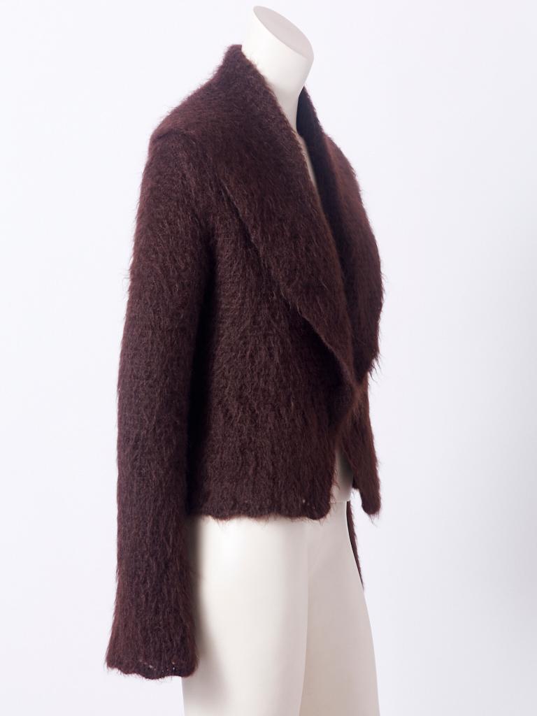 Hermès, chocolate brown, mohair, cardigan, having a shawl collar, long exaggerated sleeves and a crochet, openwork pattern detail at the cuffs and lower part of the cardigan. Interior is lined in silk chiffon. No closures.