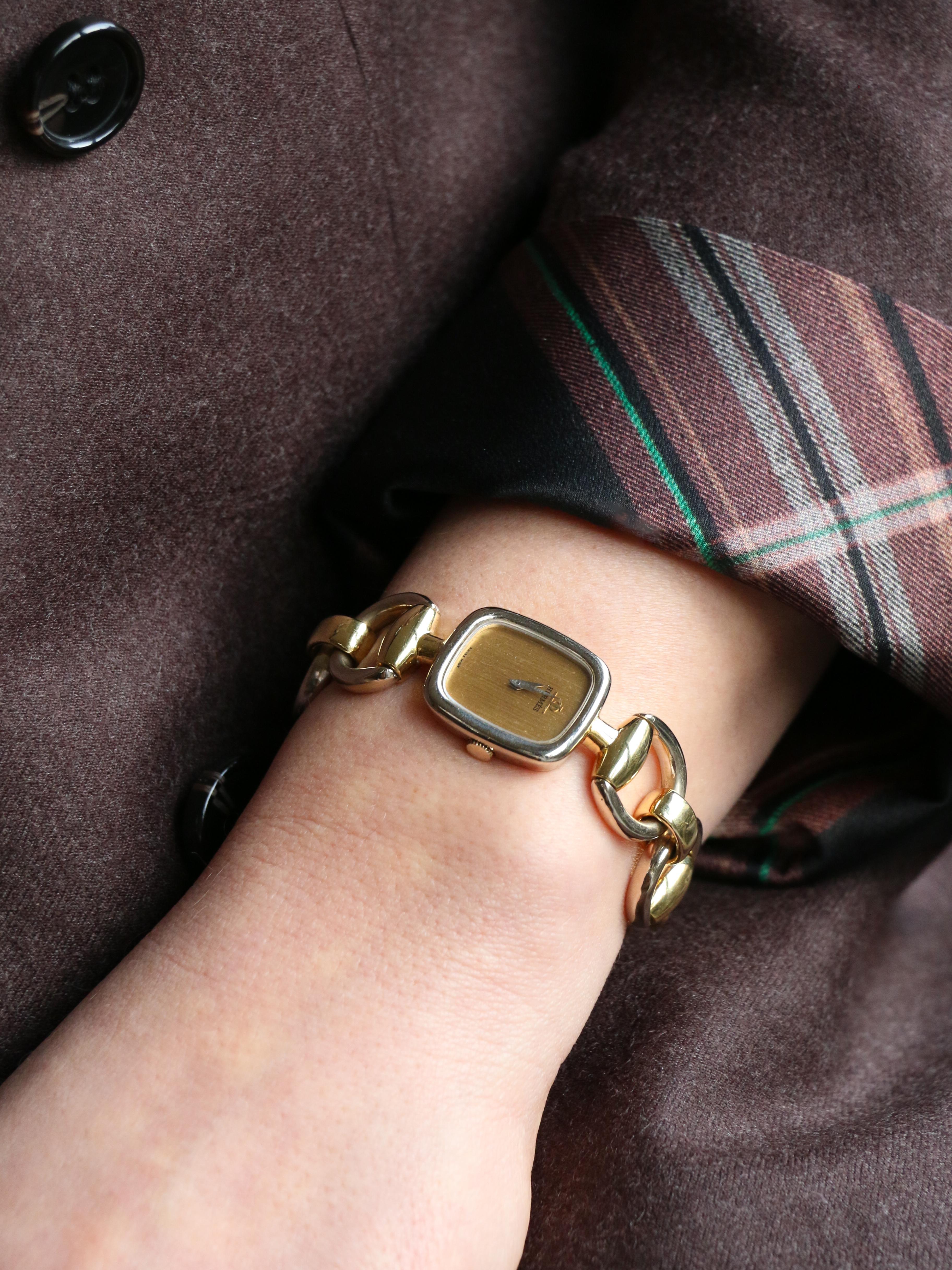 Mors Watch in Yellow and White 18k Gold (750‰). The square dial is signed Hermès and features the Baume & Mercier logo. Mechanical movement by Baume & Mercier with manual winding. Movement number BM775. Stamped with the owl hallmark for 18k gold and
