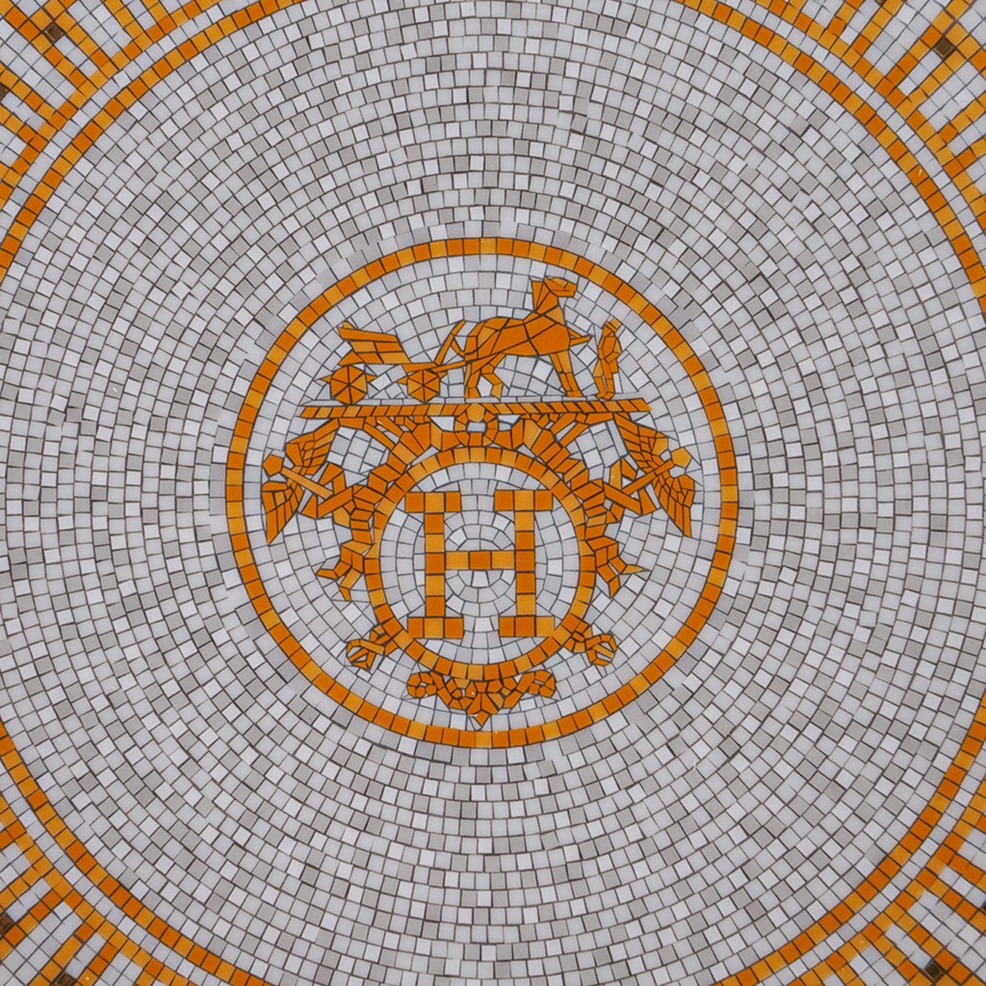 Mightychic offers a gold Hermes Mosaique Au 24 Dessert Plate featured in porcelain.
The mosaic motif reflects the mosaic floor at the entrance of the 24 Faubourg St. Honore flagship store in Paris.
For an elegant table.
Wonderful for home or