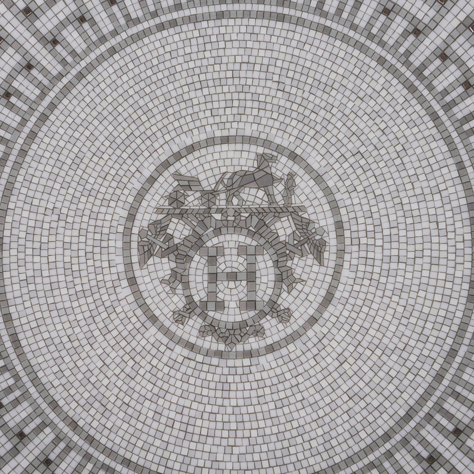 Mightychic offers an Hermes Mosaique Au 24 Platinum Dessert Plate Set of 2 in porcelain.
The mosaic motif reflects the mosaic floor at the entrance of the 24 Faubourg St. Honore flagship store in Paris.
For an elegant table.
Wonderful for home or