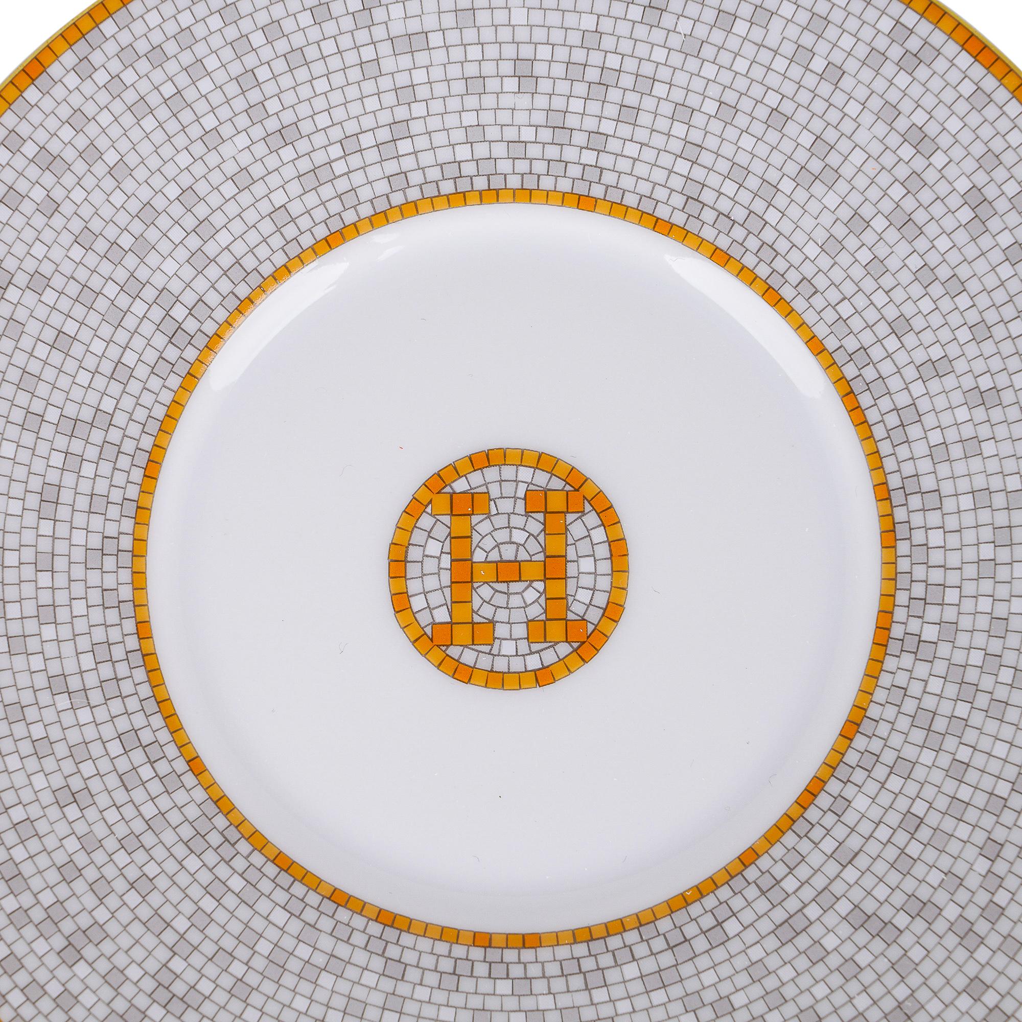 Mightychic offers an Hermes Mosaique Au 24 Gold set of two teacups and saucers.
This beautiful porcelain Hermes Mosaique tea set creates a perfect setting for any table.
Inspired by the setting of the Paris Hermes flagship store 24 Faubourg