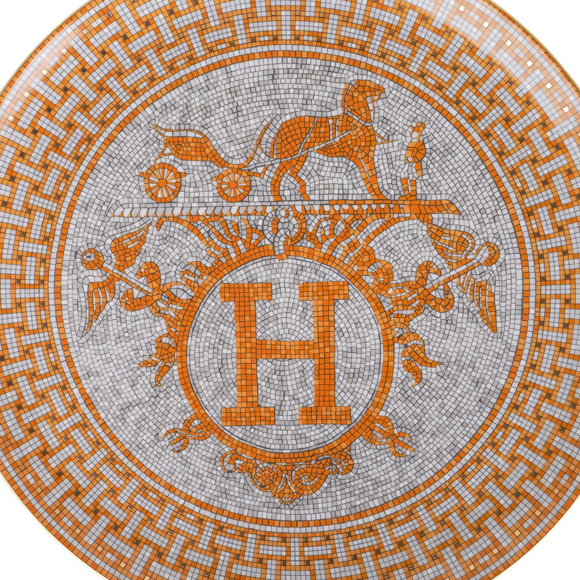 Mightychic offers an Hermes Mosaique Au 24 Gold Tart Platter in porcelain.
The mosaic motif reflects the mosaic floor at the entrance of the 24 Faubourg St. Honore flagship store in Paris.
A perfect accent piece for any room.
Wonderful for home or