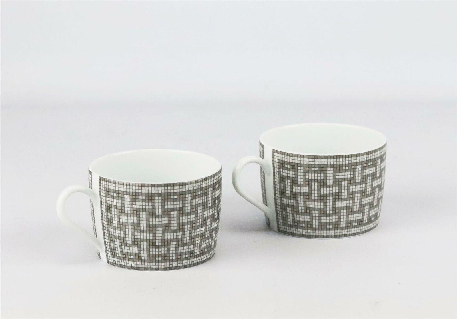 Set of 2 platinum, grey and white porcelain Hermès Mosaïque Au 24 breakfast cup with tile design throughout, gilt accents and brand stamp on the bottom.
Does not come with box.

Dimensions: H 2.25 x D 3 inches.
More available, please