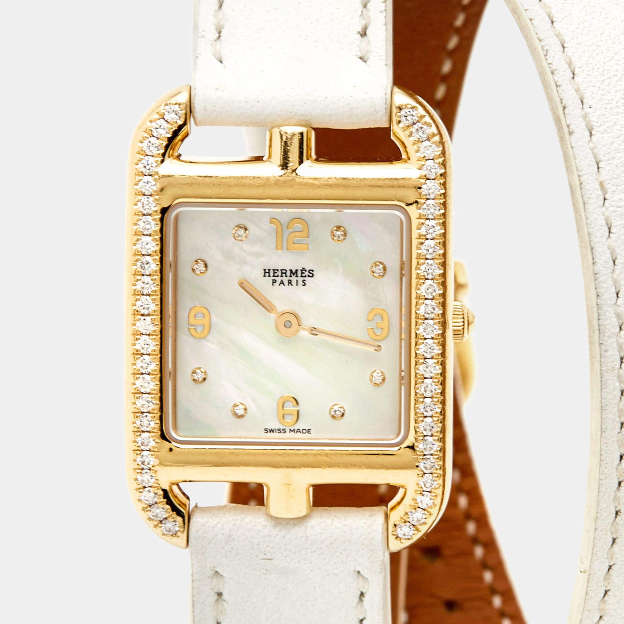 This women's wristwatch from Hermes will add a luxe touch to your everyday style. It is crafted from 18k yellow gold, and it has a mother-of-pearl dial and the perfect addition of diamonds, elevating its beauty. The watch is finished with a double