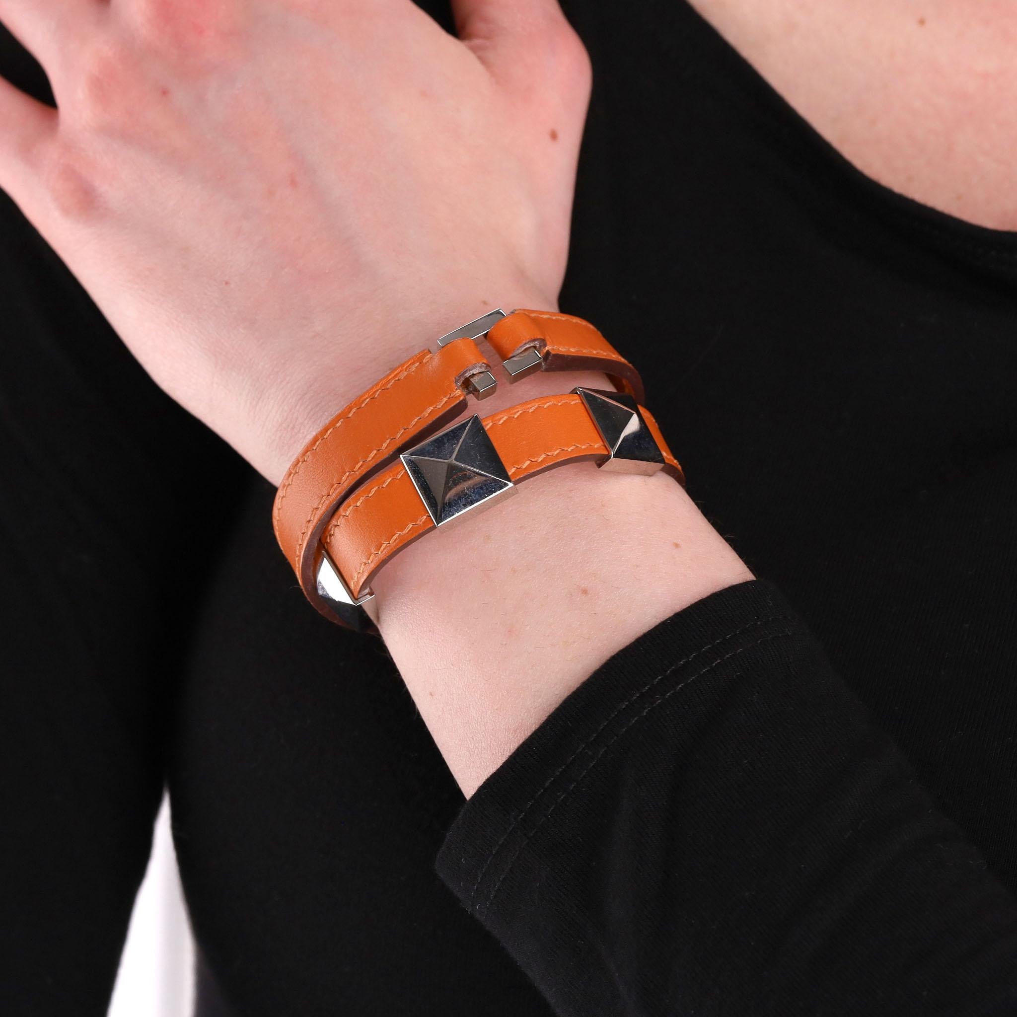 Hermes Multi Stud Medor Rockstud Leather Wrap Bracelet

Leather double strap bracelet in orange designed with three silver palladium pyramid studs.

Date stamp J in a square - 2006.

Size - One Size

Condition - Very Good

Composition - Leather,