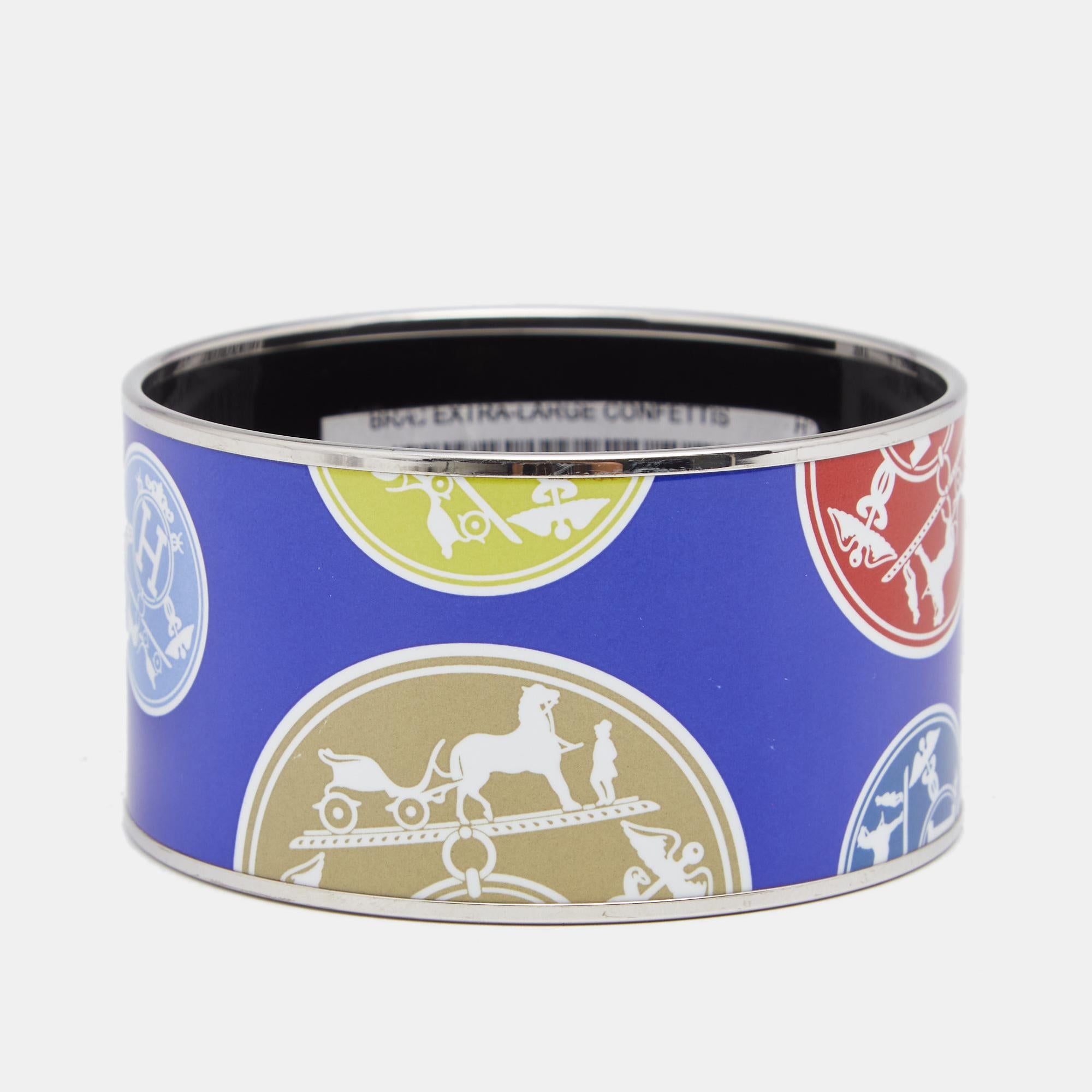 This Hermès Confettis D'Ex Libris bracelet is designed in a wide silhouette using palladium-plated metal and enamel. Wear it solo or stack it with other similar bracelets.

Includes: Price Tag ( Partially torn )