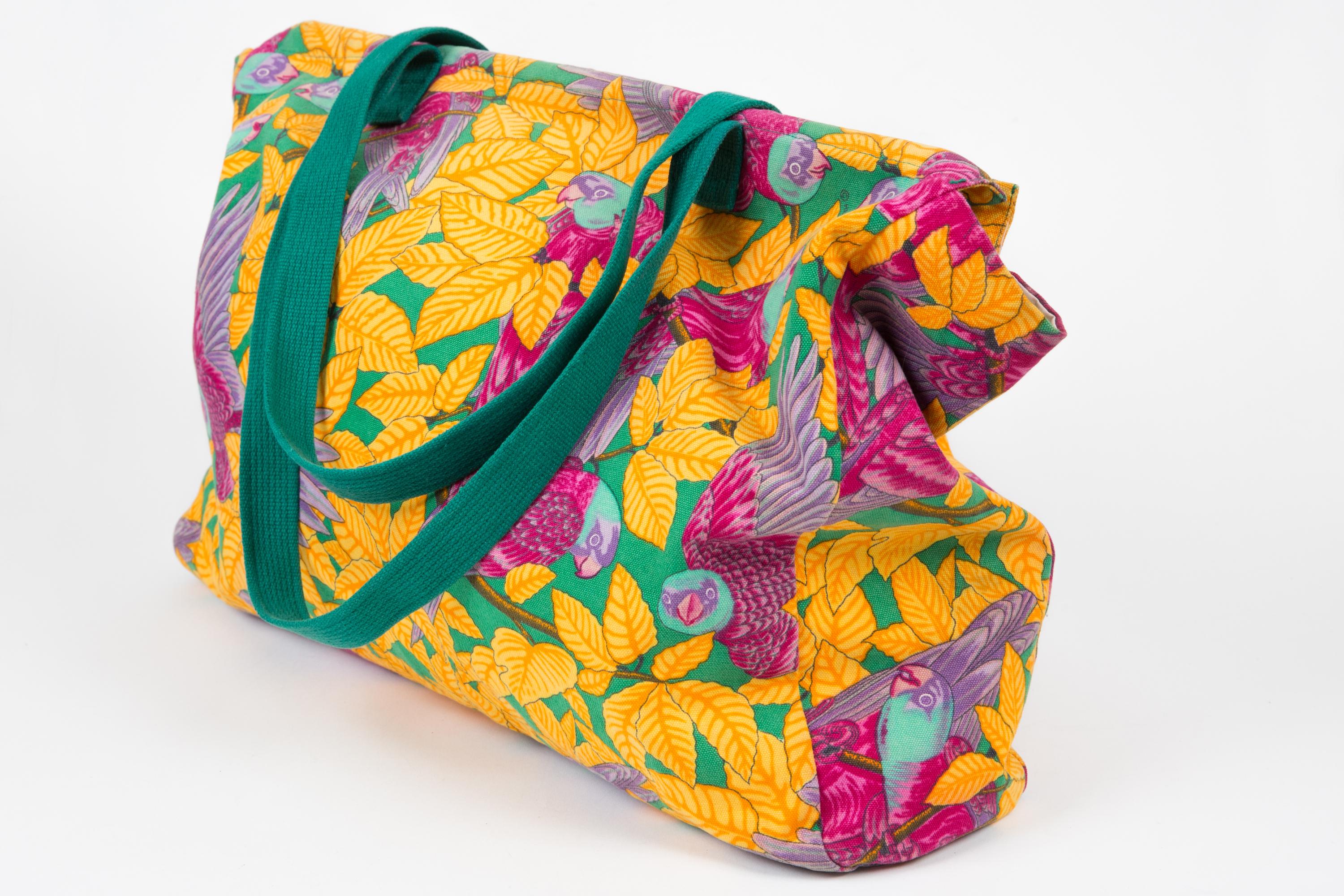Multicolor “Les Perroquets” printed canvas large tote bag from Hermès Pre-Owned featuring a jungle print, green cotton handles, inside ivory cotton lining, inside pockets, inside compartments, and a tag label. 
Circa 2000s.  100% Cotton. 
In good