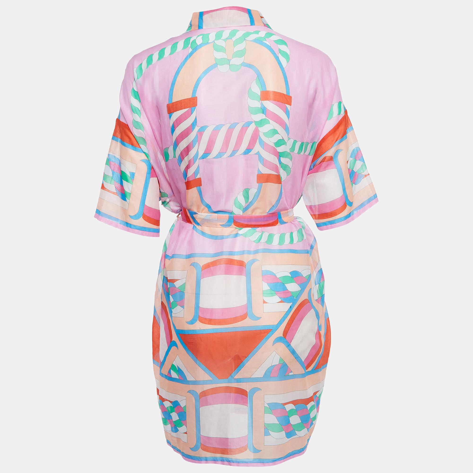 The Hermès dress is a vibrant and versatile garment featuring a canoe-inspired print. Crafted from high-quality cotton, it combines comfort with elegance, making it perfect for beach outings or as a stylish cover-up. The multicolored design adds a