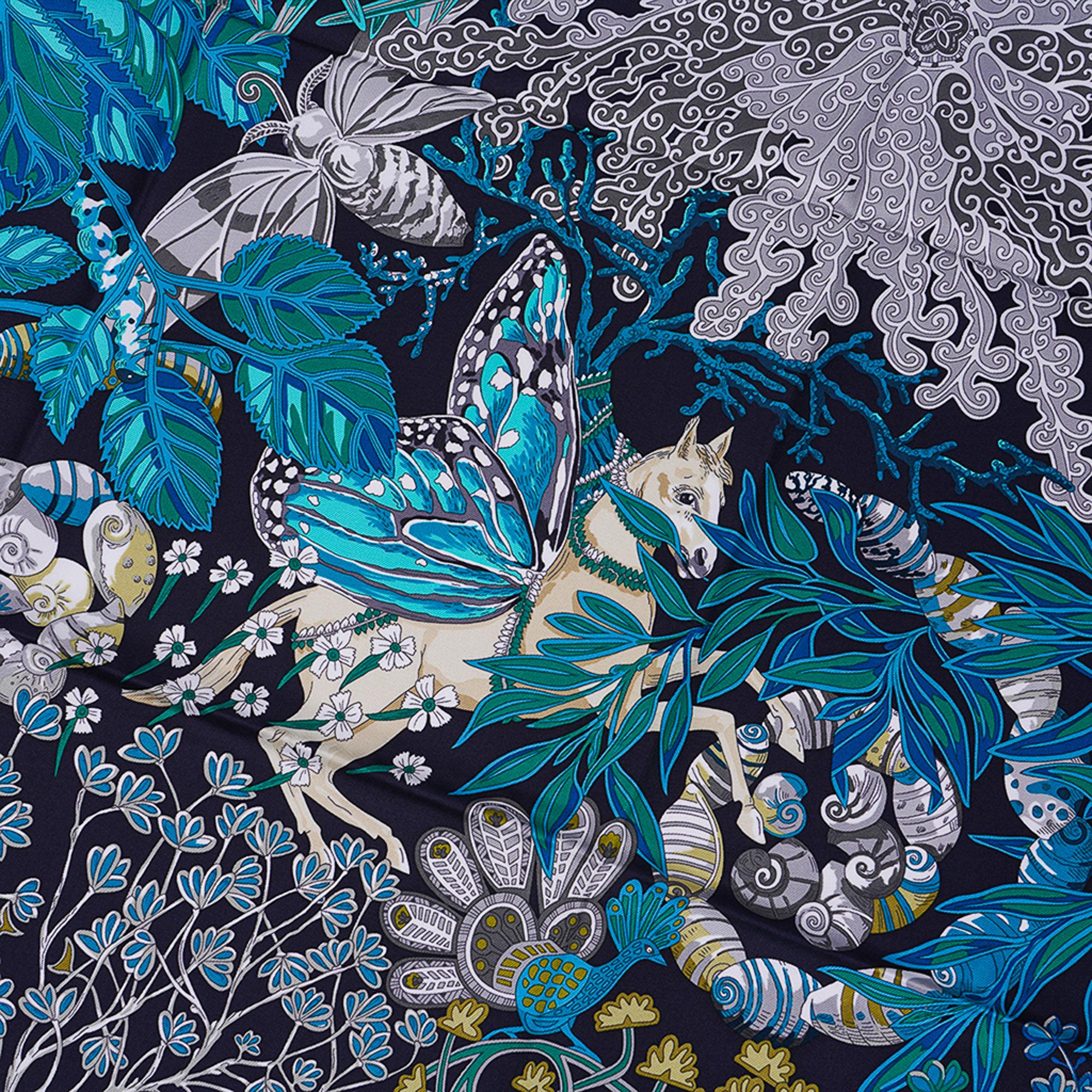 Mightychic offers a rare Hermes Mythes et Metamorphoses silk scarf in rich exotic Marine, Turquoise and Vert.
Designed by Annie Faivre.
Depicts a beautiful blend of animals and tropical florals, some in the Metamorphoses state inspired by Ovid and