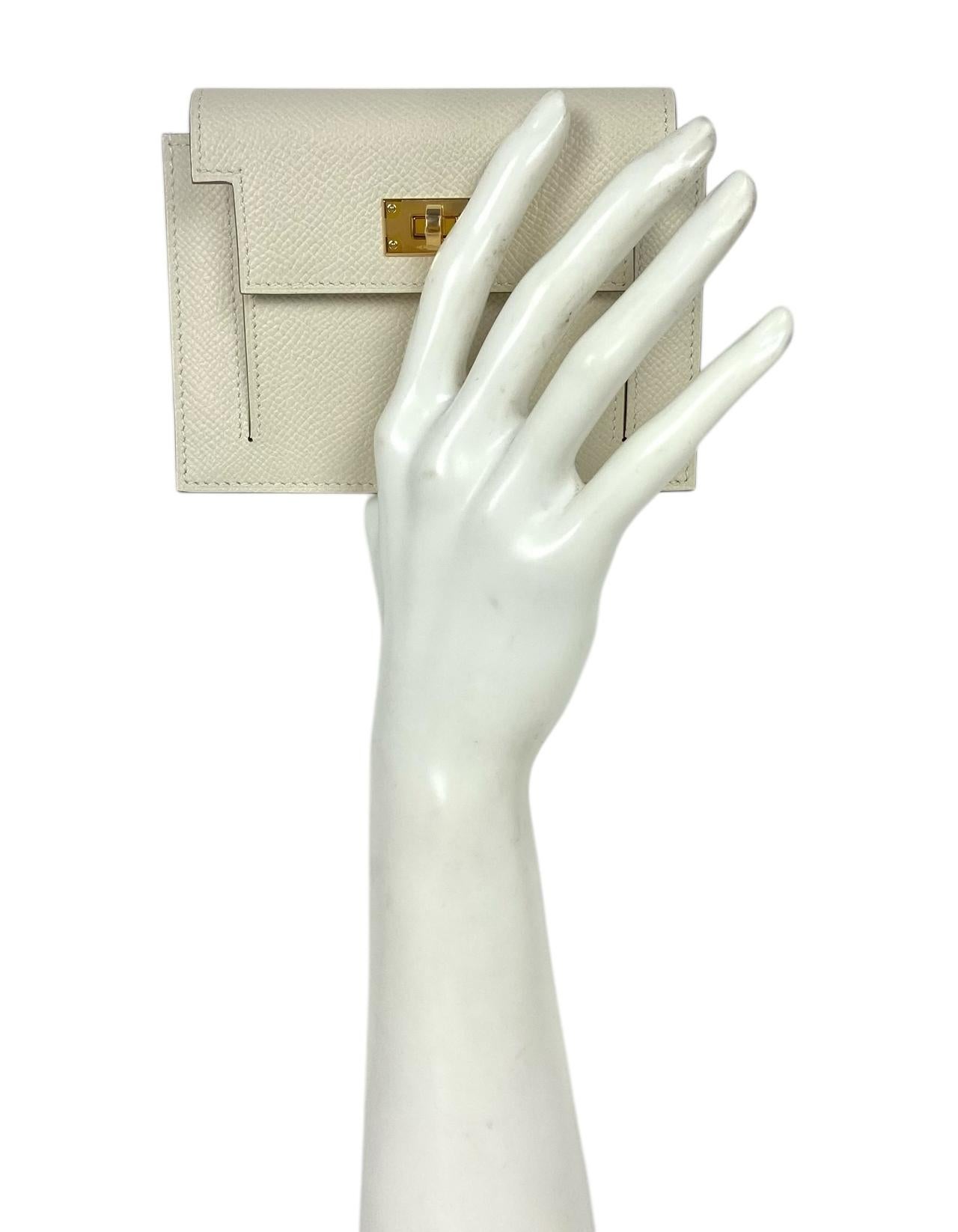 Hermes Nata Epsom Leather Kelly Pocket Compact Wallet 

Made In: France
Color: Nata
Hardware: Goldtone
Materials: Epsom leather
Lining: Leather
Closure/Opening: Twistlock
Exterior Pockets: Zip back pocket
Interior Pockets: One compartment
Exterior