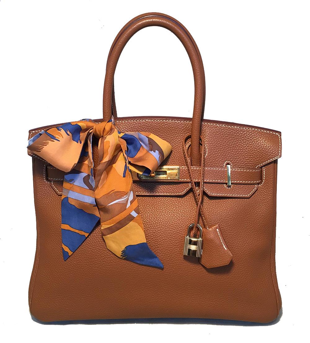 Hermes Natural Tan Togo 30cm Birkin Bag in excellent condition. Natural tan togo leather with gold hardware and white topstitching. Signature double strap twist top flap closure opens to a tan kidskin lined interior that holds one zipped and one