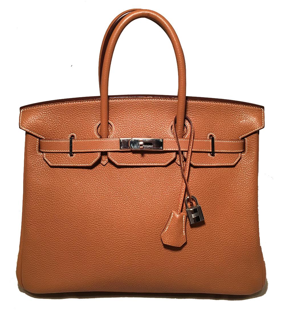 Hermes Natural Tan Togo Leather 35 cm Birkin Bag in excellent condition. Natural tan togo leather exterior trimmed with silver palladium hardware. Signature front double strap twist closure opens to a matching tan kidskin lined interior that holds