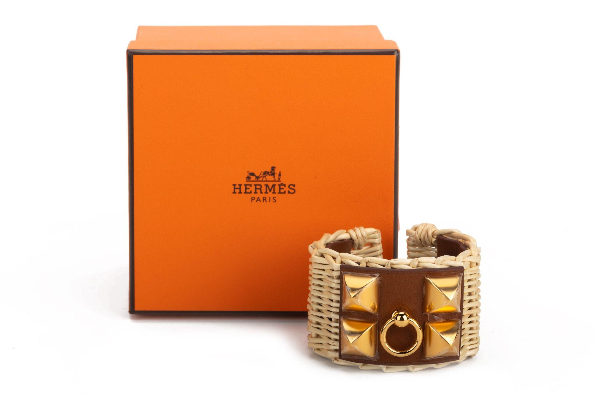 Hermès Natural Wicker cuff bracelet with brown leather feature and golden studs. The piece is in excellent condition and comes with a box.