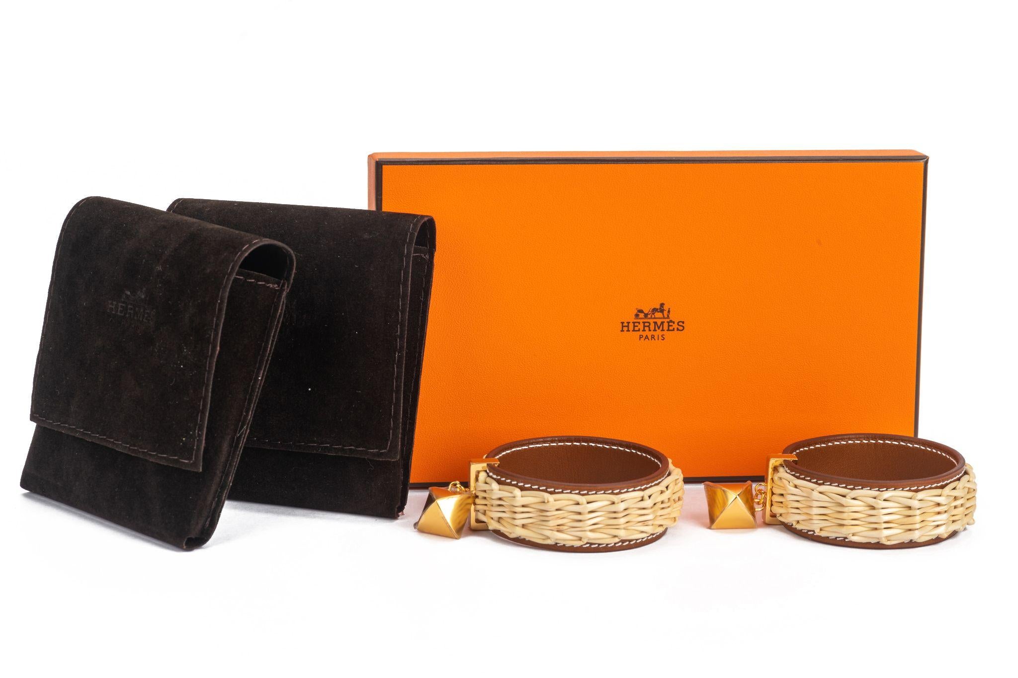 Hermès natural wicker earrings with leather features. The earrings are like creoles and have gold studs. They are new and come with a pouch and original box.