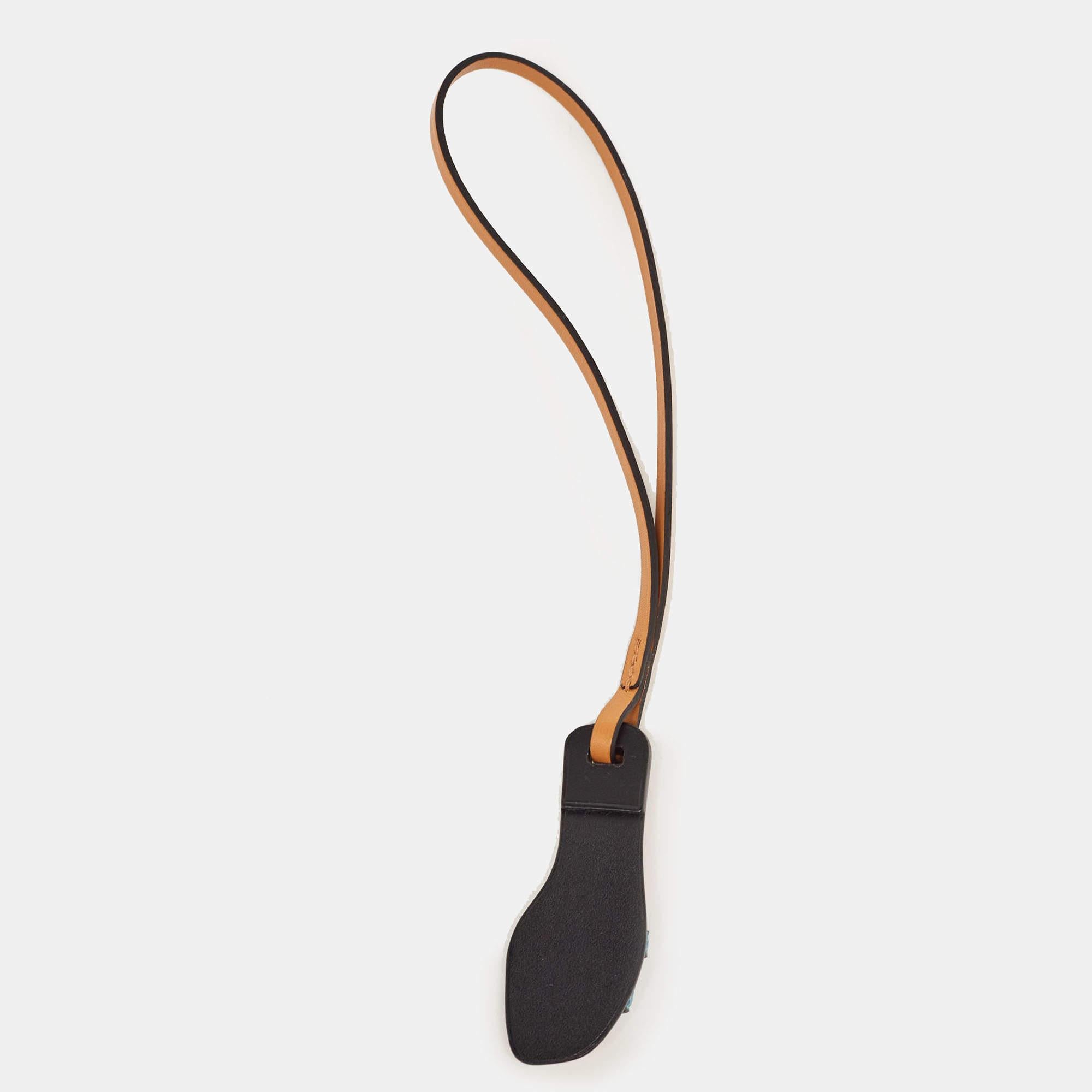 Decorate your favorite bags with this Hermes Oran nano charm, designed as a little version of the brand's iconic Oran slide sandal. It is made of leather and lizard.

Includes: Original Box

