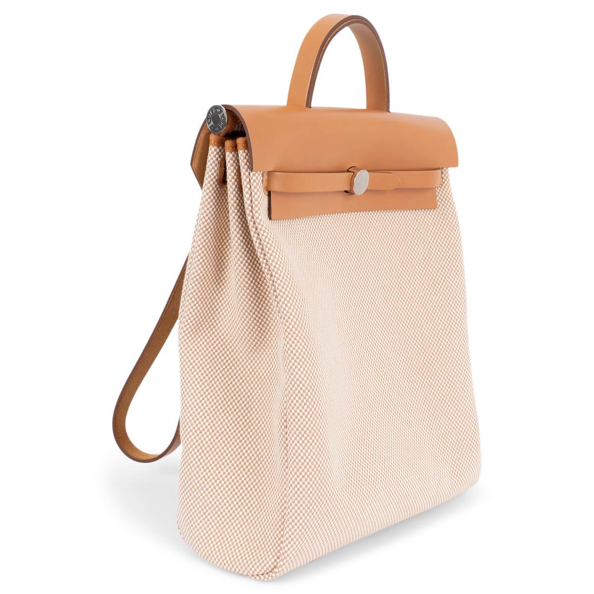 100% authentic Hermès Herbag a Dos Zip Retourne backpage in Naturel Vache Hunter leather and Ecru-Beige Toile Criss Viking canvas. Features a zip pocket on the outside back, palladium plated hardware and a leather top handle and straps. Closes with