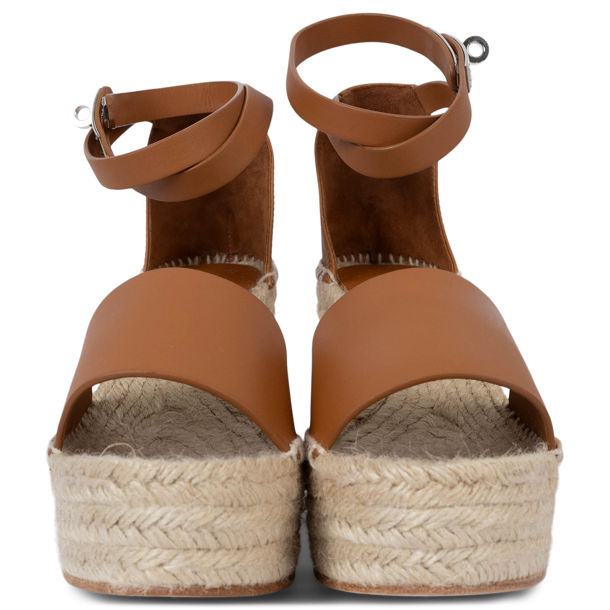 100% authentic Hermès Tipoli espadrille wedge sandals in smooth Gold goatskin with iconic Palladium plated buckle, wrap-around ankle strap and natural rope heel. Brand new. 

Measurements
Model	H191098Z A3390
Imprinted Size	41 (run small)
Shoe