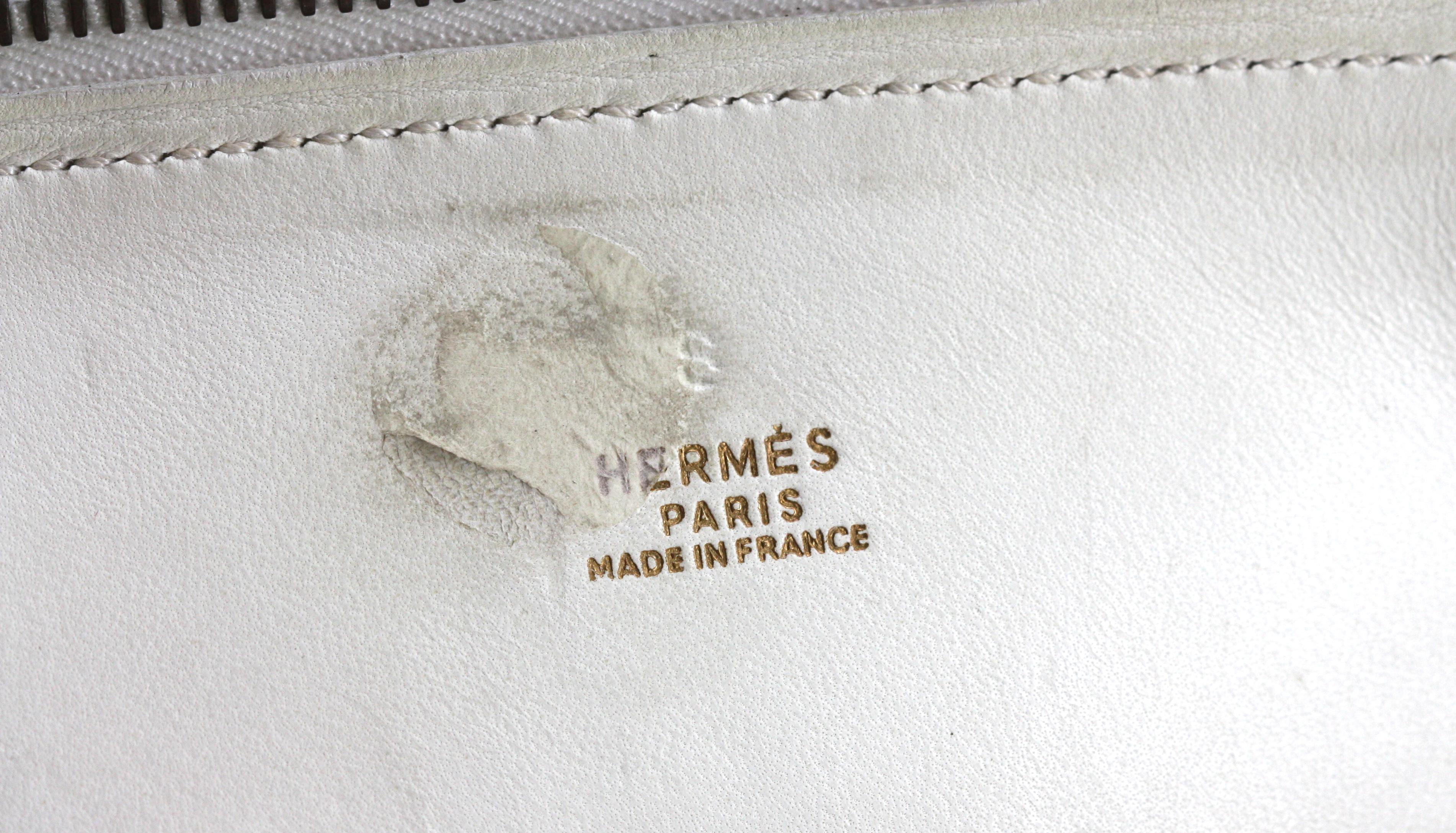 
Hermes Navaho White Epsom Leather Bolide Handbag
Marked in numerous places on leather and fittings.
Solid white epsom leather with gold toned front and back stud details and gold toned hardware, double rounded loop handles, with white 34 in strap,