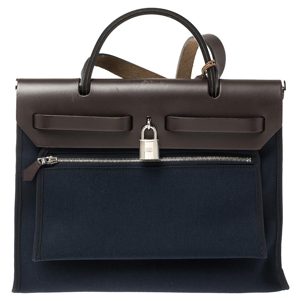 Made from navy blue canvas and brown leather, the Herbag Zip is just as outstanding as all of Hermes' other handbags. First introduced in 2009 as a new version of the Herbag, this piece comes with a single handle, a long shoulder strap and it