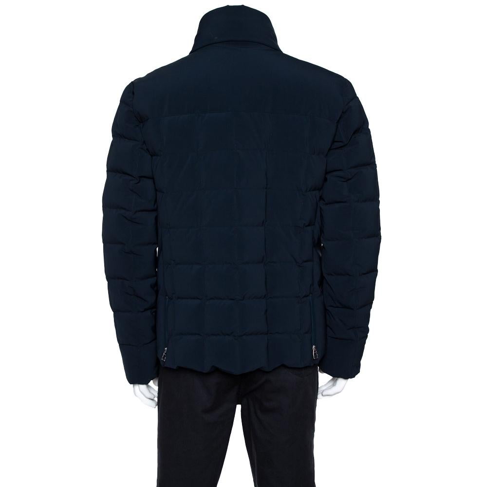 Tailored to perfection is this exclusive and classy puffer jacket from the house of Hermes. Navy blue in color, this would take your style game to a whole new level. It is designed in a simple & sleek style with a zip closure on the front and snap