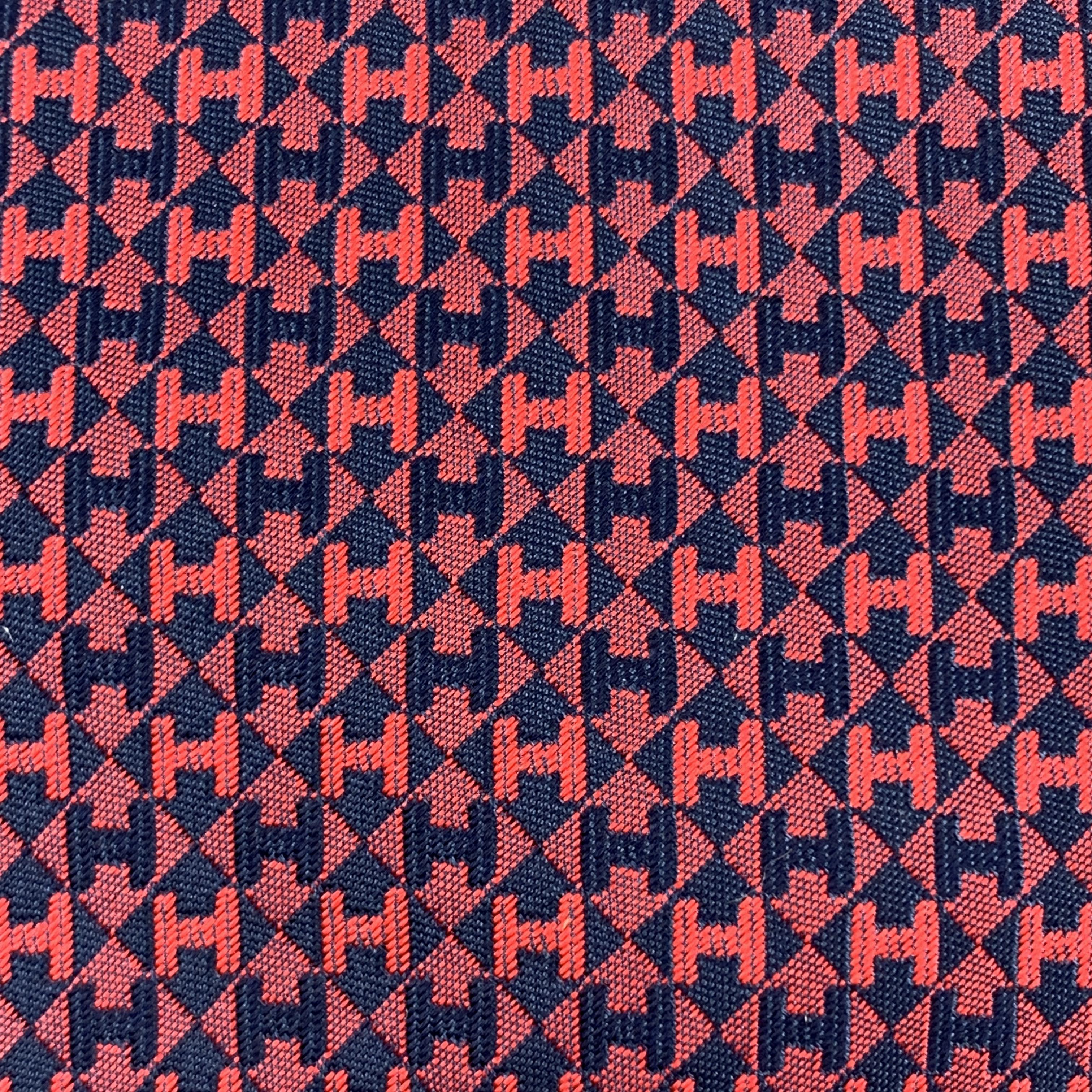 HERMES TIE comes in silk with red and navy blue geometric diamond color block H print. With box. Made in France.
 
Excellent Pre-Owned Condition.
 
Width: 3.5 in.