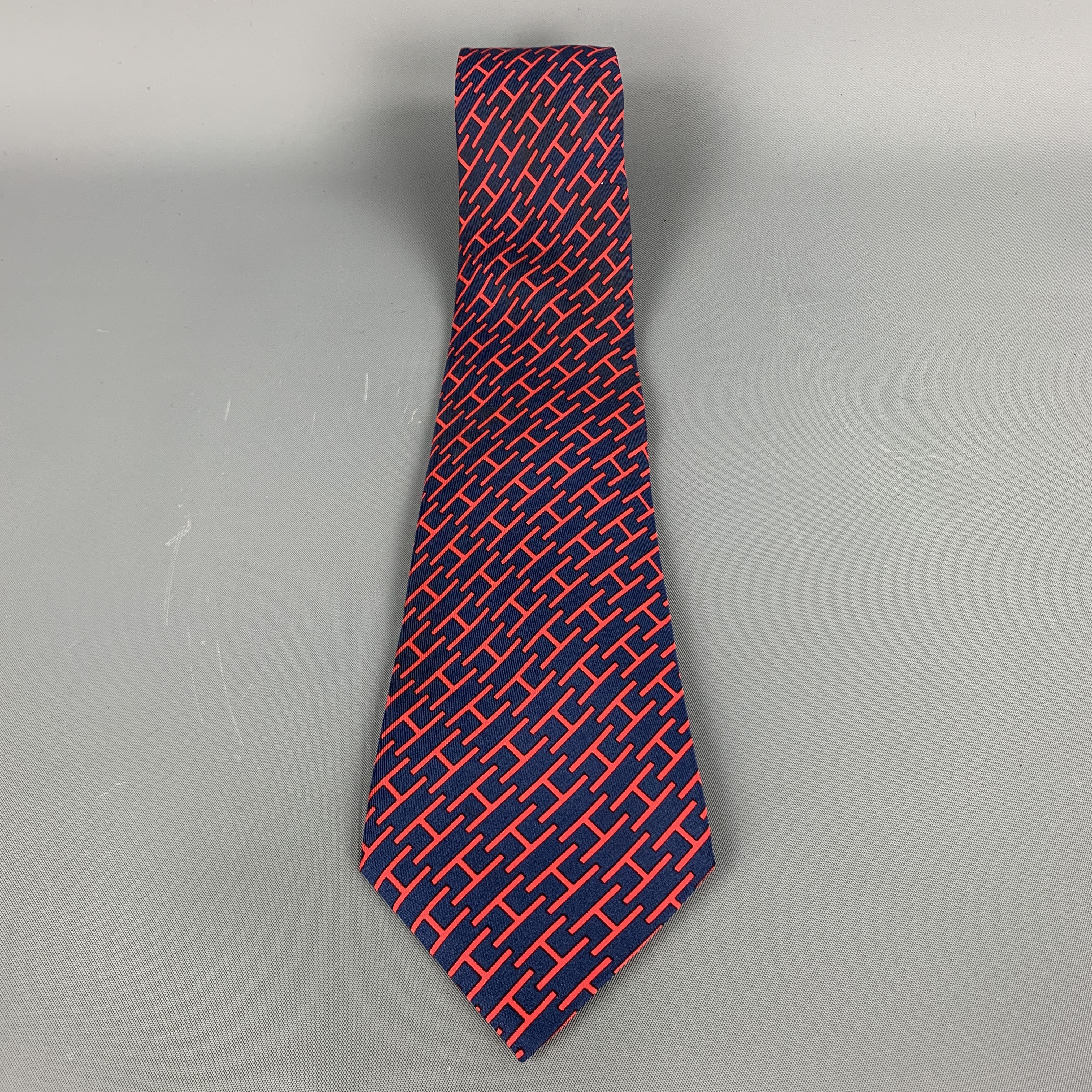 Vintage Hermes necktie comes in a navy and red silk twill with all over 