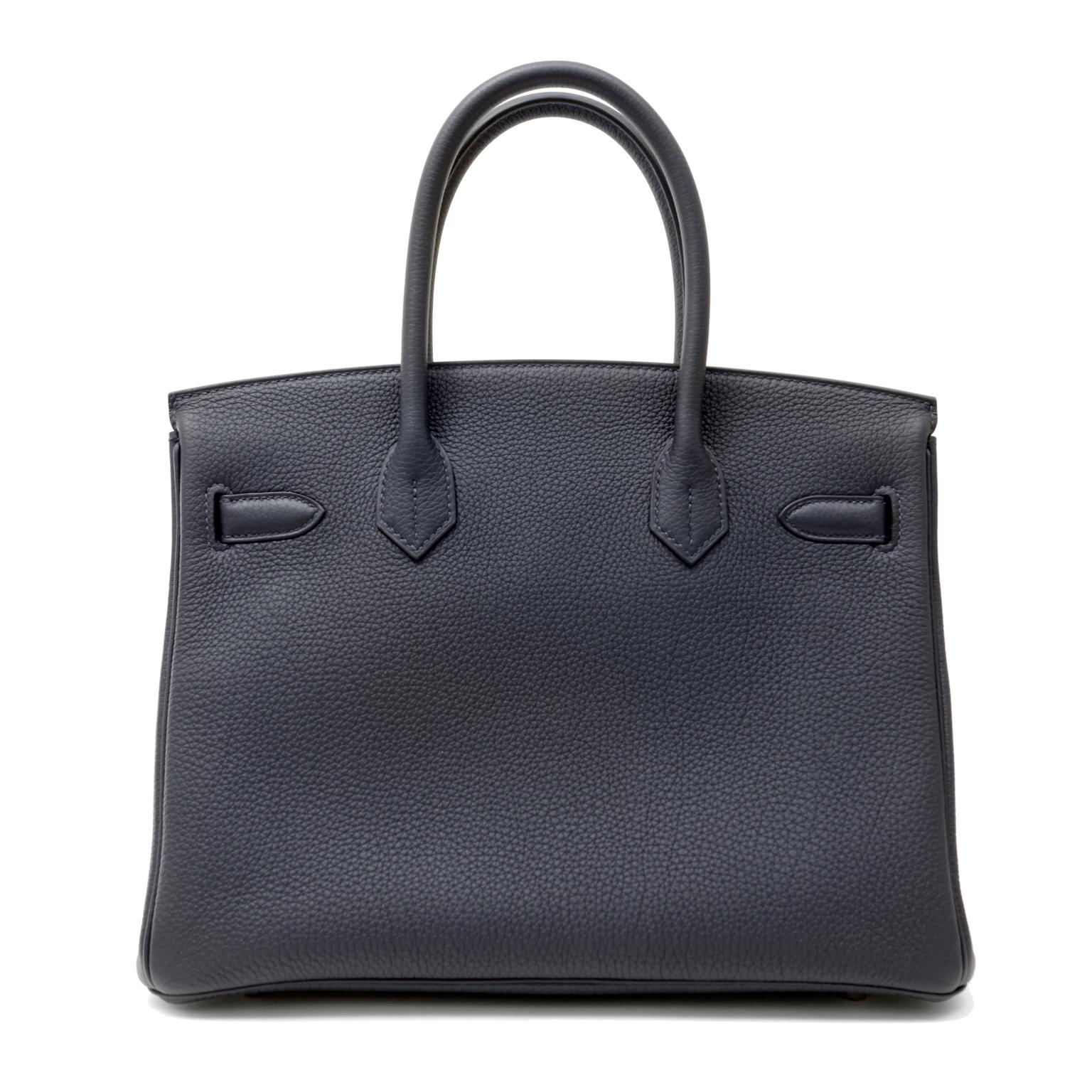 This authentic Hermès Navy Togo 30 cm Officier Birkin is pristine with the protective plastic intact on the hardware. Breathtakingly stunning in deep navy blue Togo leather with dark green accent striping and interior.  
Durable and textured Navy