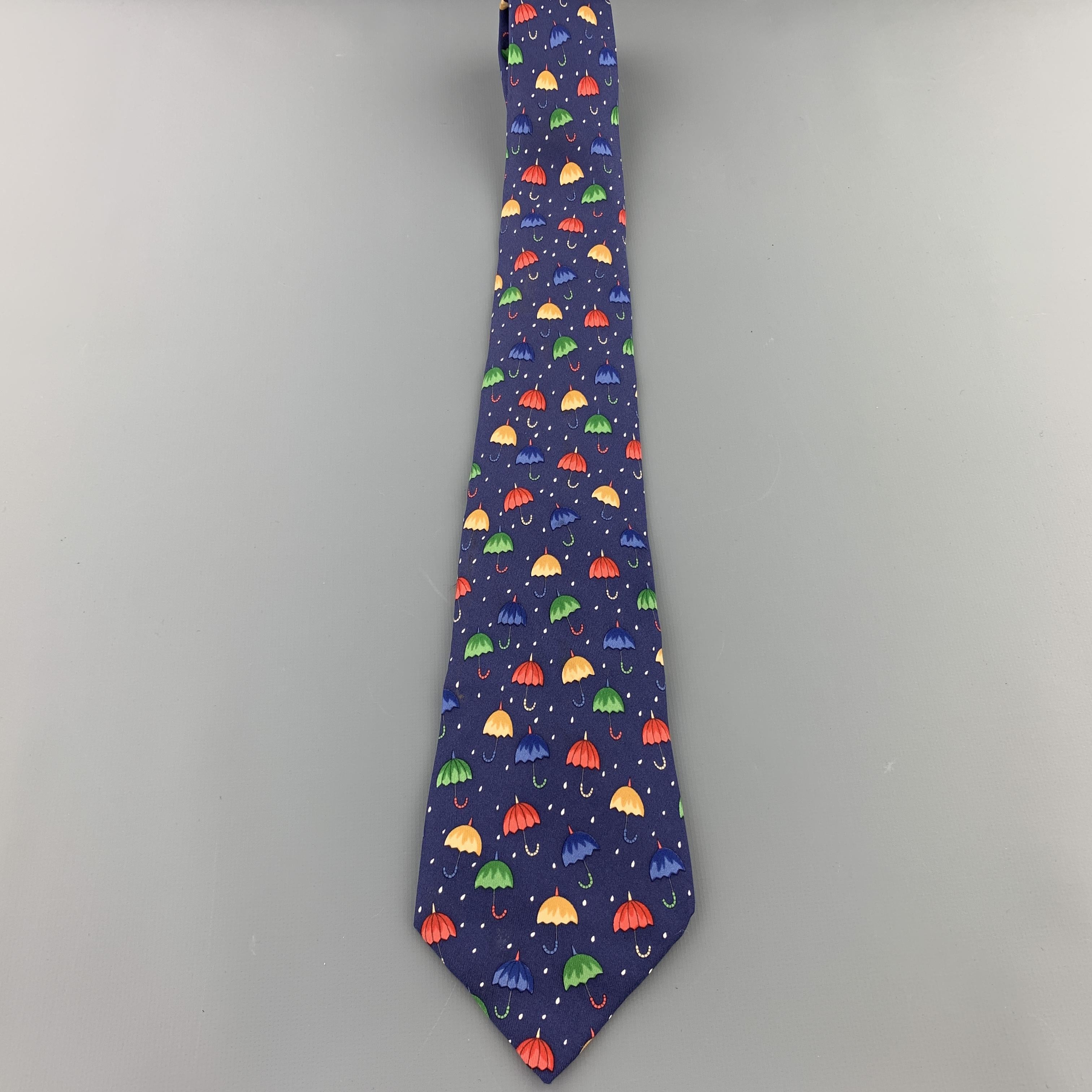 HERMES necktie comes in navy blue silk twill with all over multi color umbrellas print. Wear throughout. As-is. Made in France.

Good Pre-Owned Condition.

Width: 3.5 in.
 