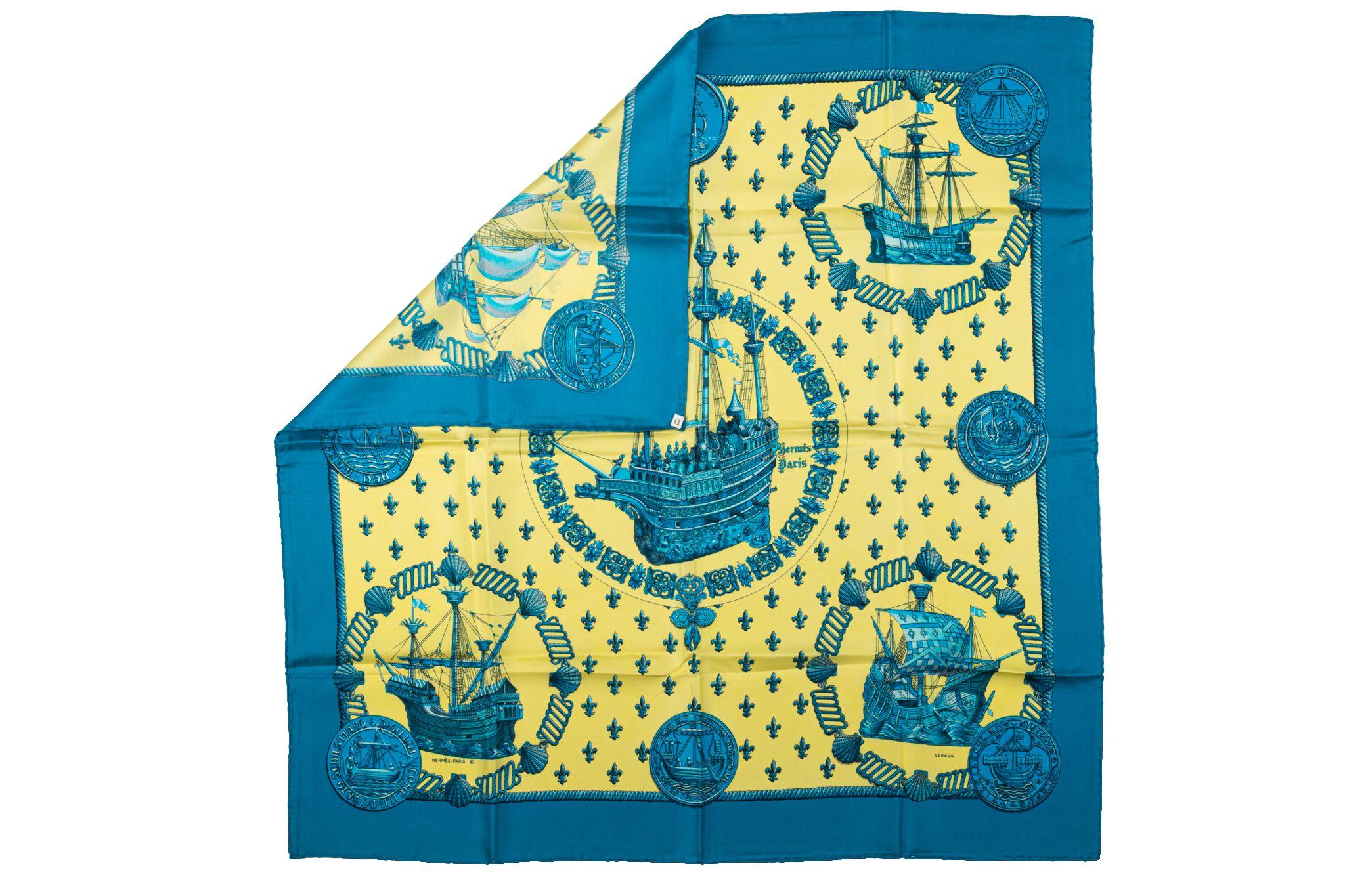 Hermès 100% silk twill Nefs d'Or scarf designed by collectible artist Ledoux. Vibrant blue and yellow colorways. Hand-rolled edges. Does not include box.
