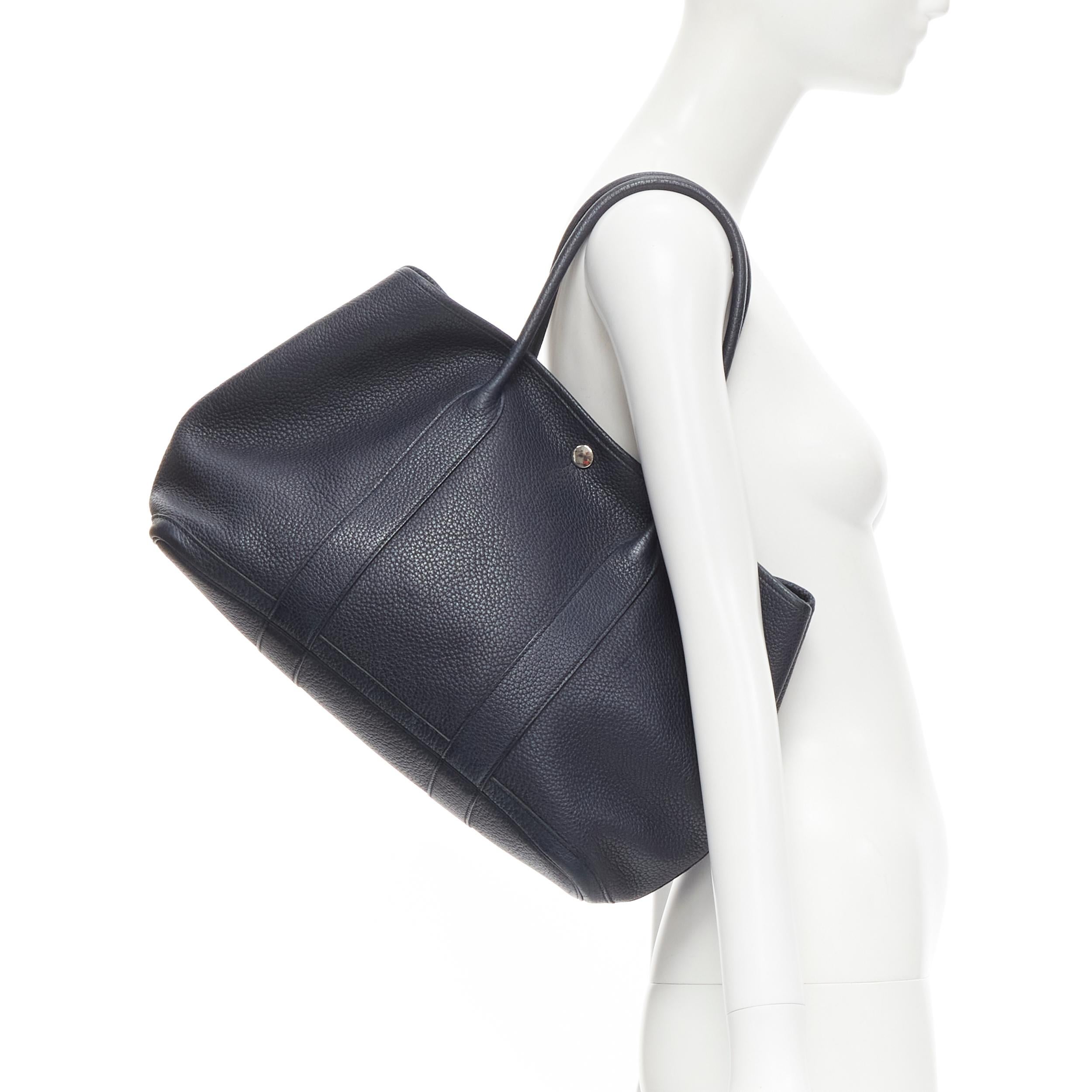 HERMES Negonda Garden Party 36 navy blue leather PHW tote bag 
Reference: JECN/A00025 
Brand: Hermes 
Model: Negonda Garden Party 36 
Material: Leather 
Color: Navy 
Pattern: Solid Closure: Button 
Made in: France 

CONDITION: 
Condition: Fair, this