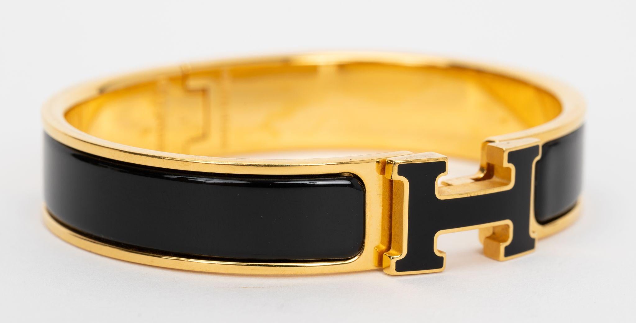 The Hermes Clic Clac H, narrow bracelet,  in black enamel with gold-plated hardware.
Size PM, new in unworn condition, comes with velvet pouch.