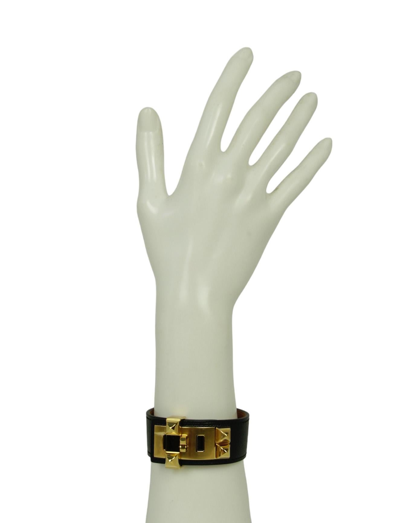 Hermes NEW Black/Gold Epsom Leather Collier de Chien 24 Bracelet sz T3

Made In: France
Color: Black/gold 
Materials: Metal, epsom leather
Overall Condition: Excellent, like new. Protective plastic still on metal
Estimated Retail: $910 +