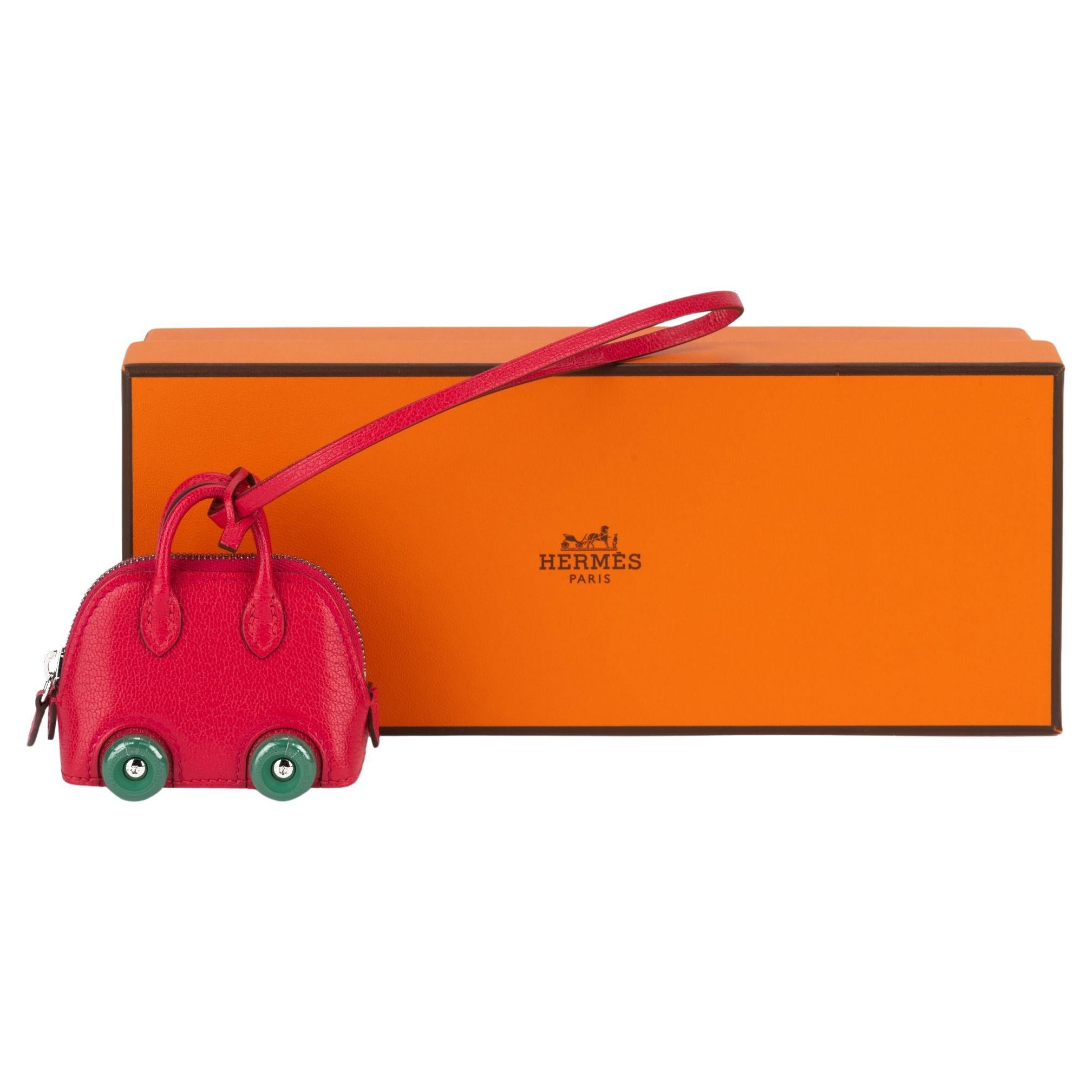 Hermès brand new super collectible bolide on wheels bag charm. Chevre mysore pink leather and green wheels. Never used, plastic on them . Functioning zipper allows to use the charm as a small pouch. Date stamp B for 2023. Comes with booklet and