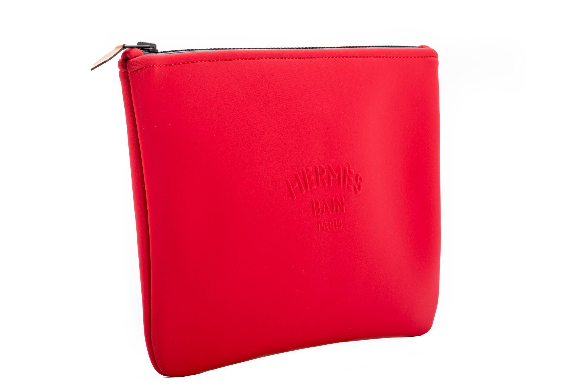 Hermès new coral red neoprene pochette/toiletry bag. comes with hermes shopping bag.