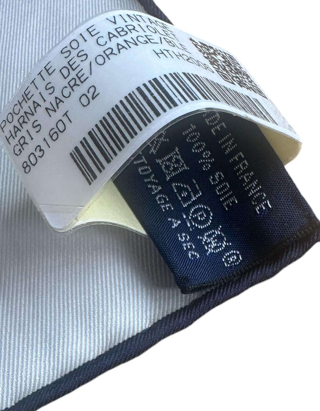 Hermes NEW Gris Nacre/ Orange/ Blue Harnais de Cabriolet Pocket Square Pochette 45 Designed by Cyrille Diatkine. 

Made In: France
Color: Gris Nacre/ Orange/ Blue
Materials: 100% Silk
Overall Condition: New condition with original tag attached. This